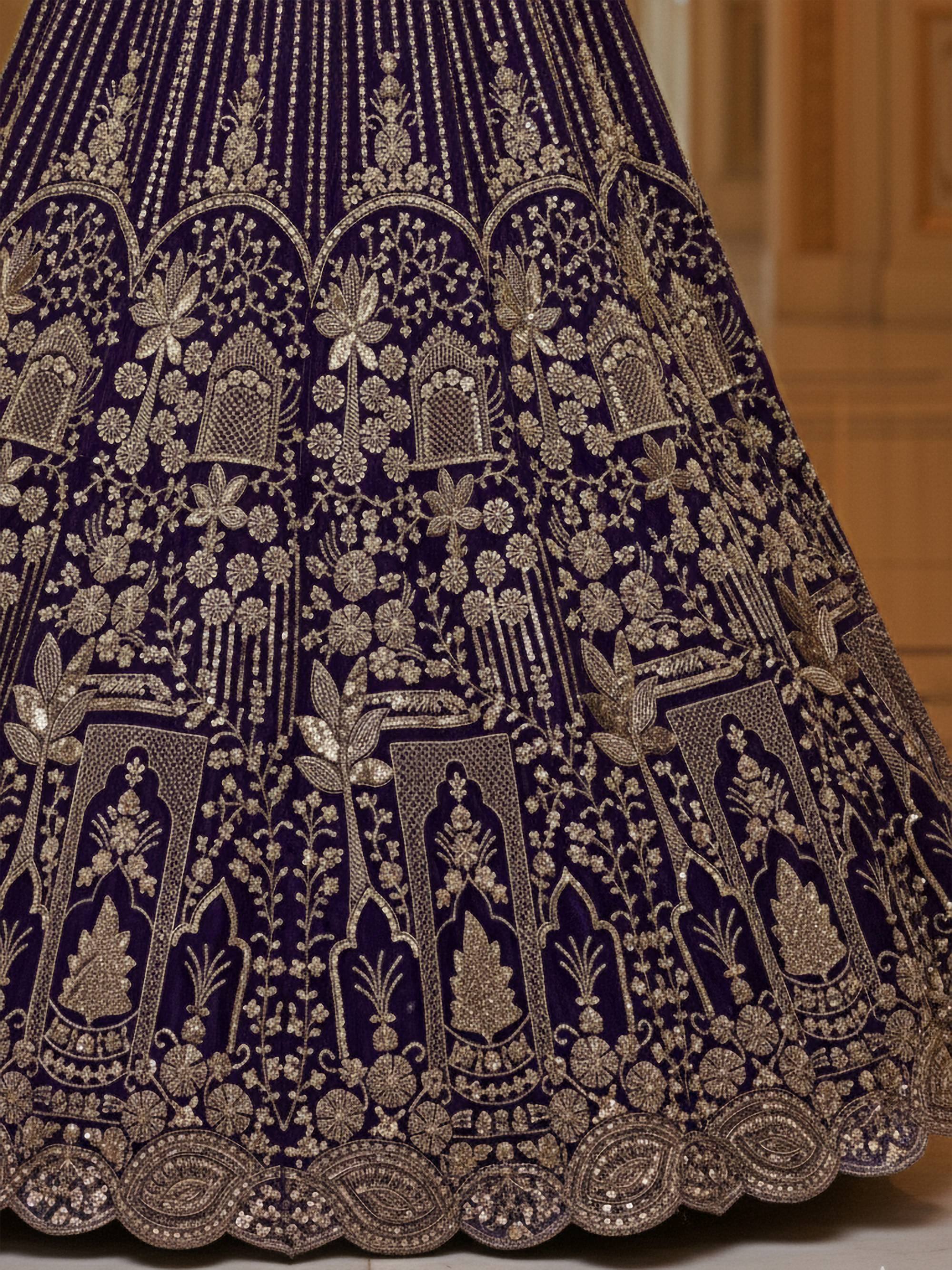 Purple velvet lehenga with intricate gold embroidery and floral motifs, perfect for Indian ethnic wear.
