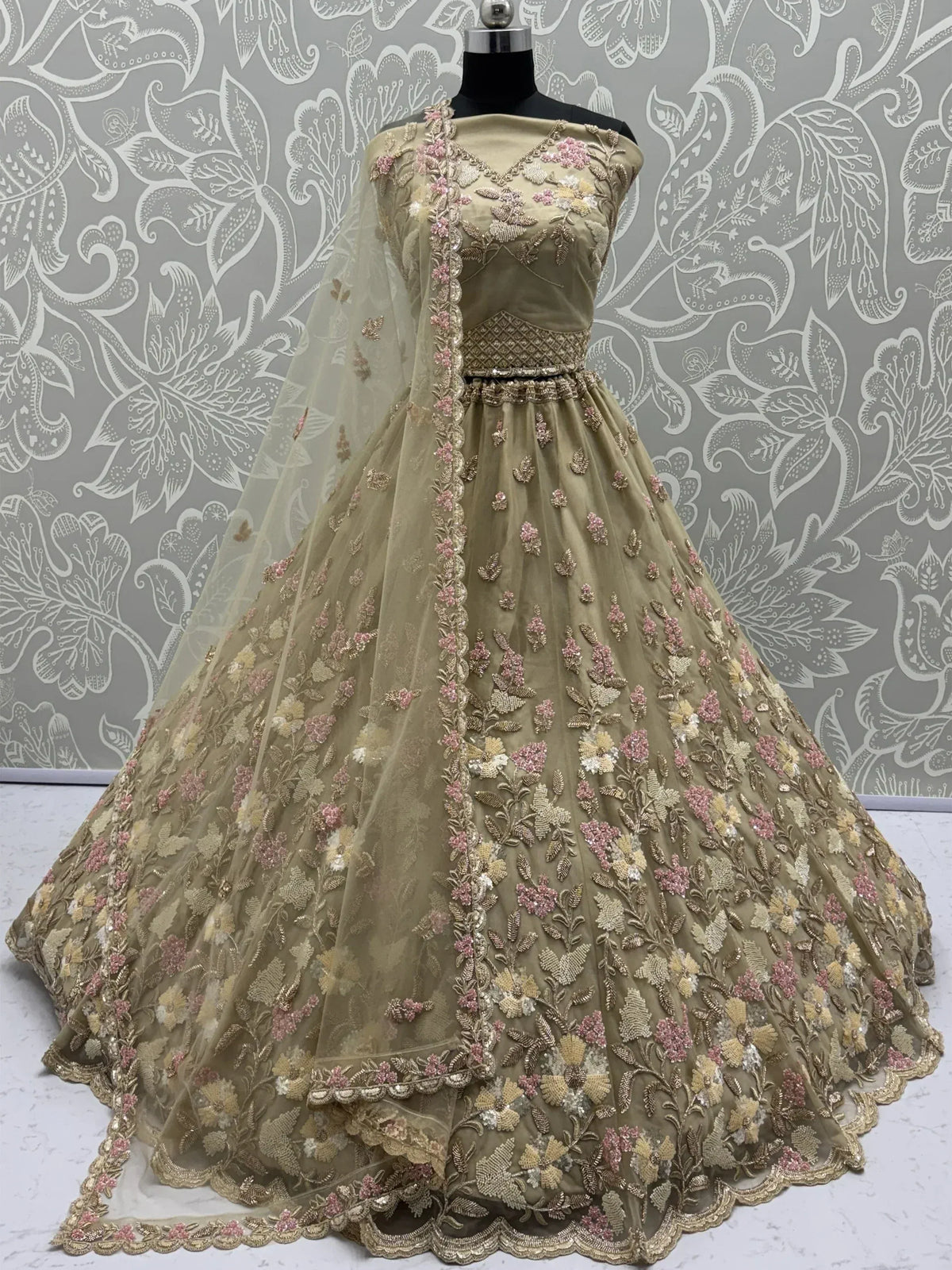 Olive green designer lehenga choli with floral embroidery and sheer dupatta, perfect for Indian weddings and parties.