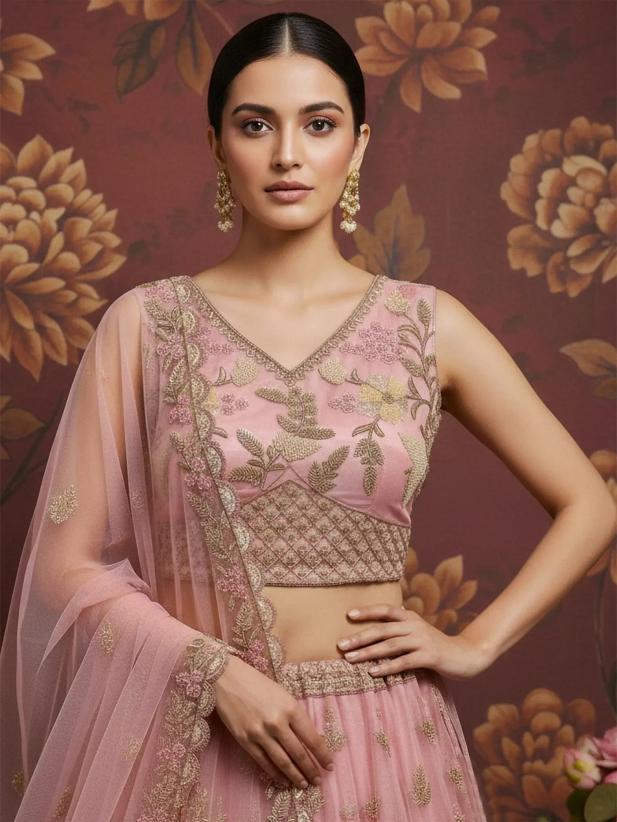 Pink embroidered lehenga choli with gold floral detailing, perfect for Indian ethnic wear occasions