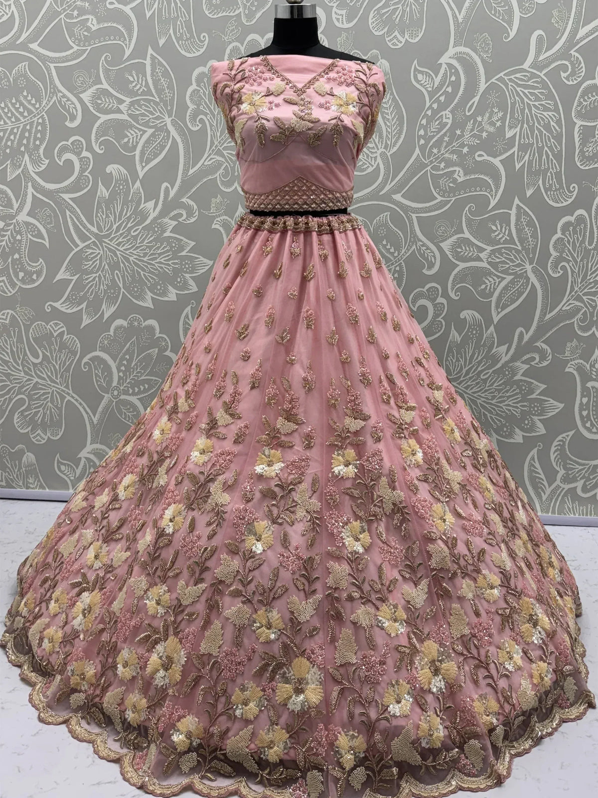 Pink floral embroidered lehenga choli with gold detailing, perfect for Indian ethnic wear occasions