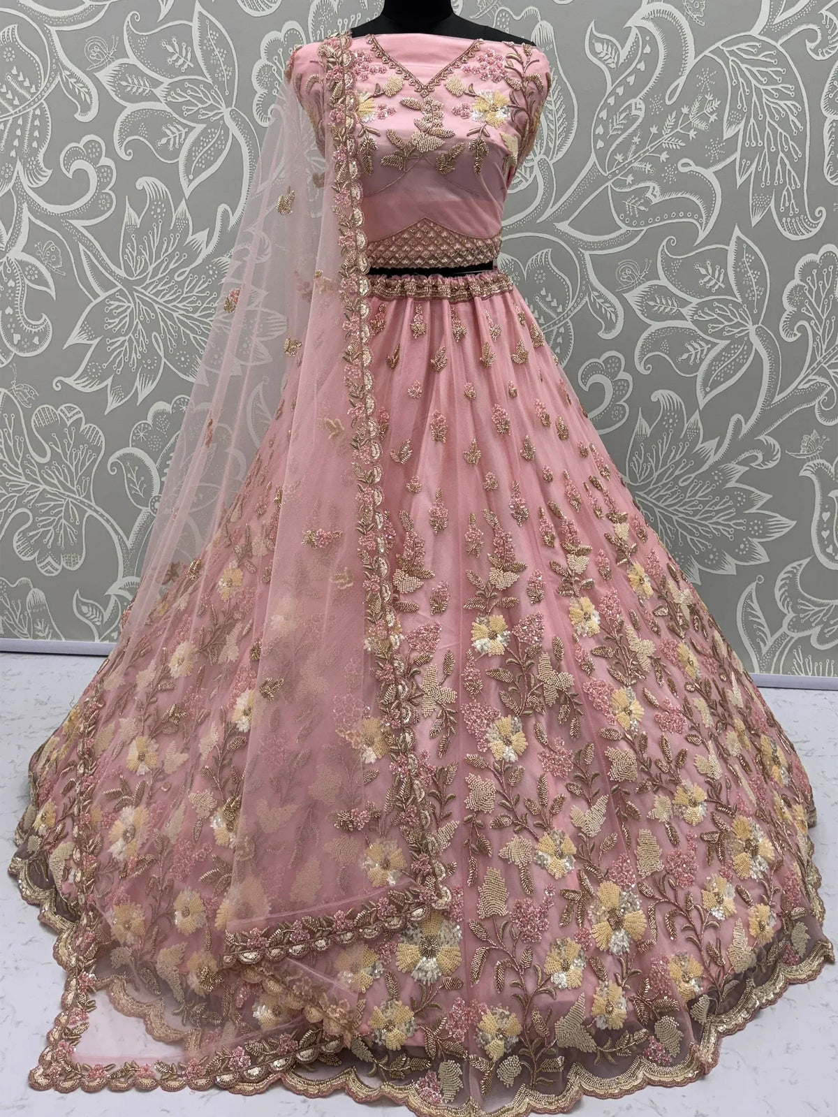 Pink floral embroidered lehenga choli with golden detailing and sheer dupatta