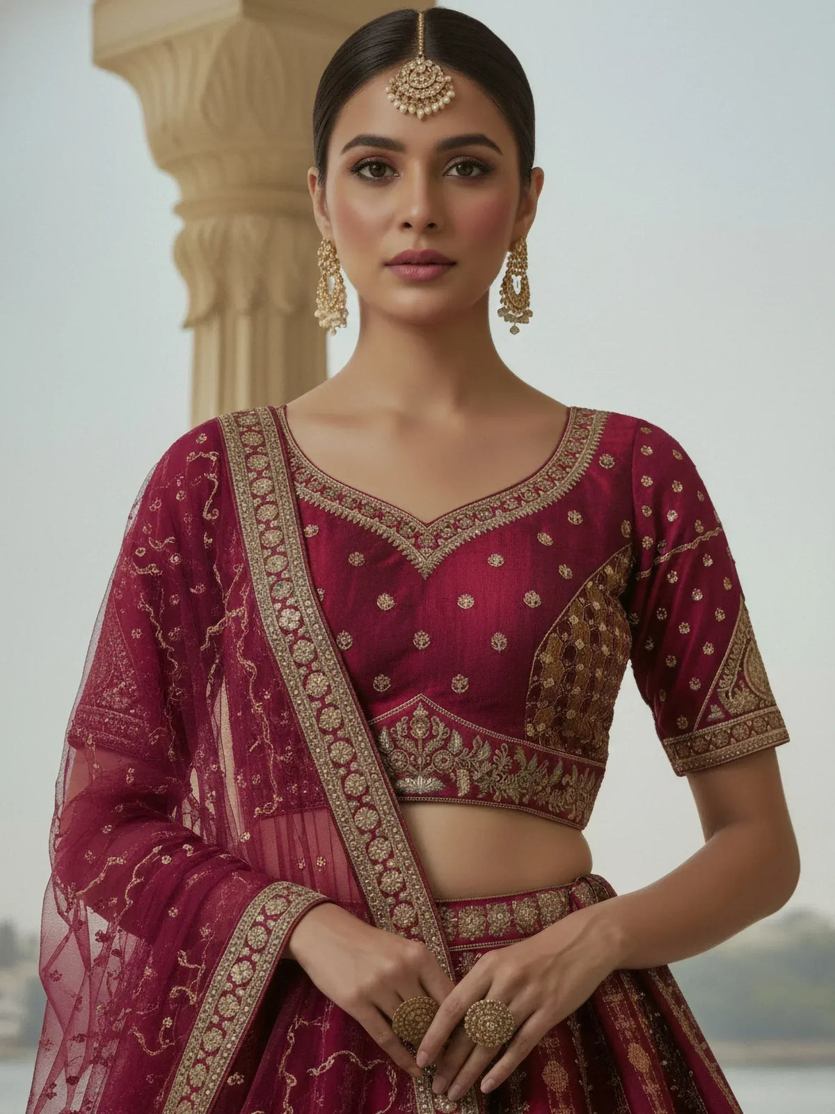 Maroon embroidered lehenga choli with gold detailing and matching dupatta for Indian ethnic wear