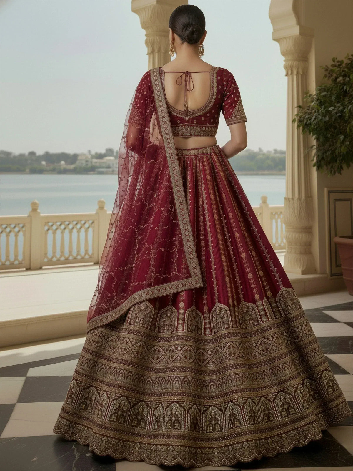 Maroon designer lehenga choli with intricate gold embroidery and sheer dupatta, perfect for Indian weddings.