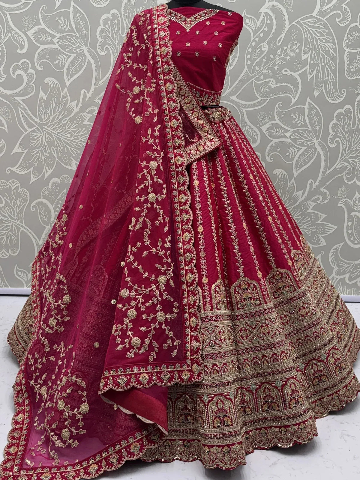 Red embroidered lehenga choli with gold detailing and floral dupatta for Indian ethnic wear