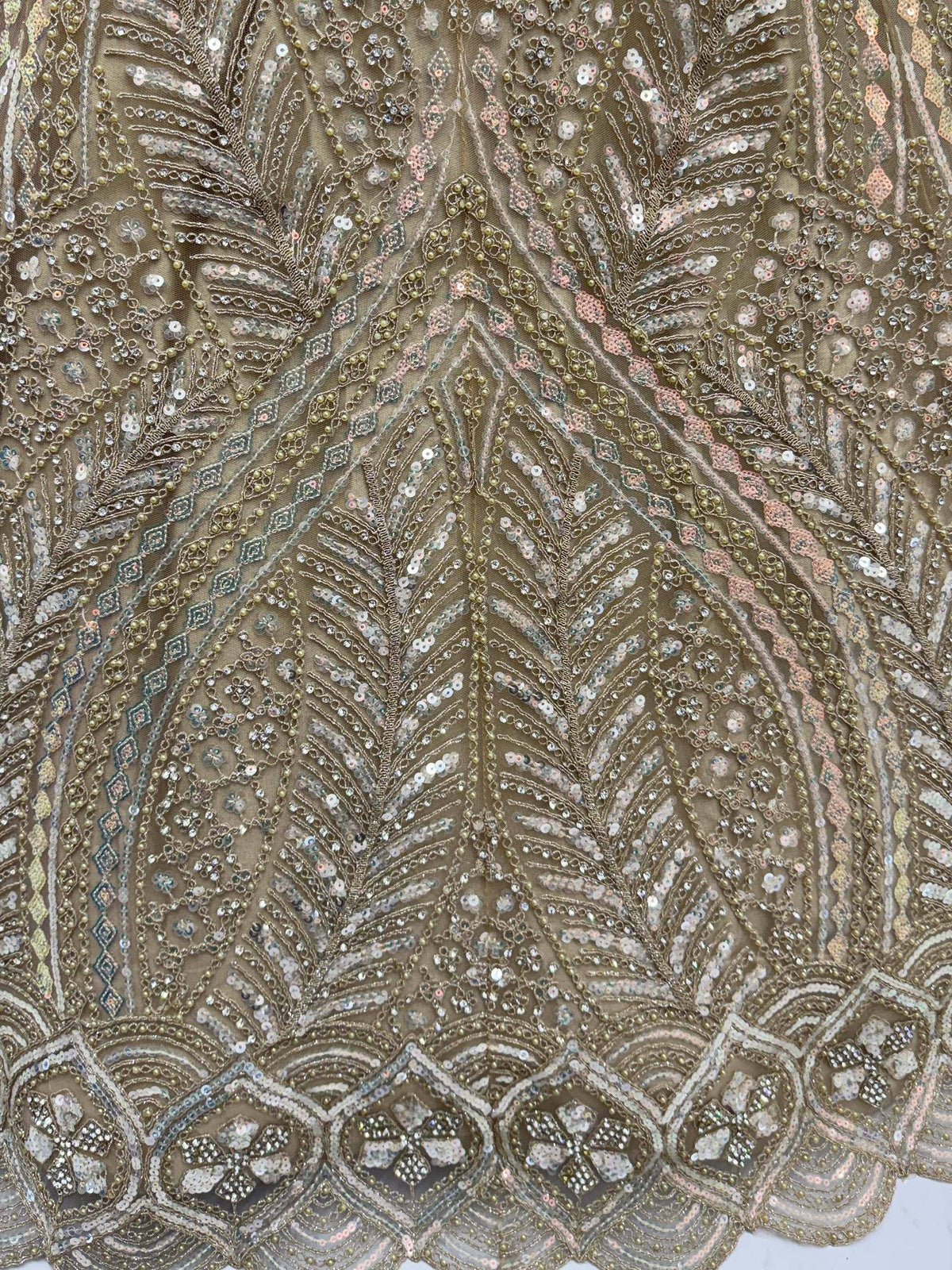 Intricate gold and silver sequin embroidery on sheer fabric, perfect for designer lehenga choli or ethnic gown.