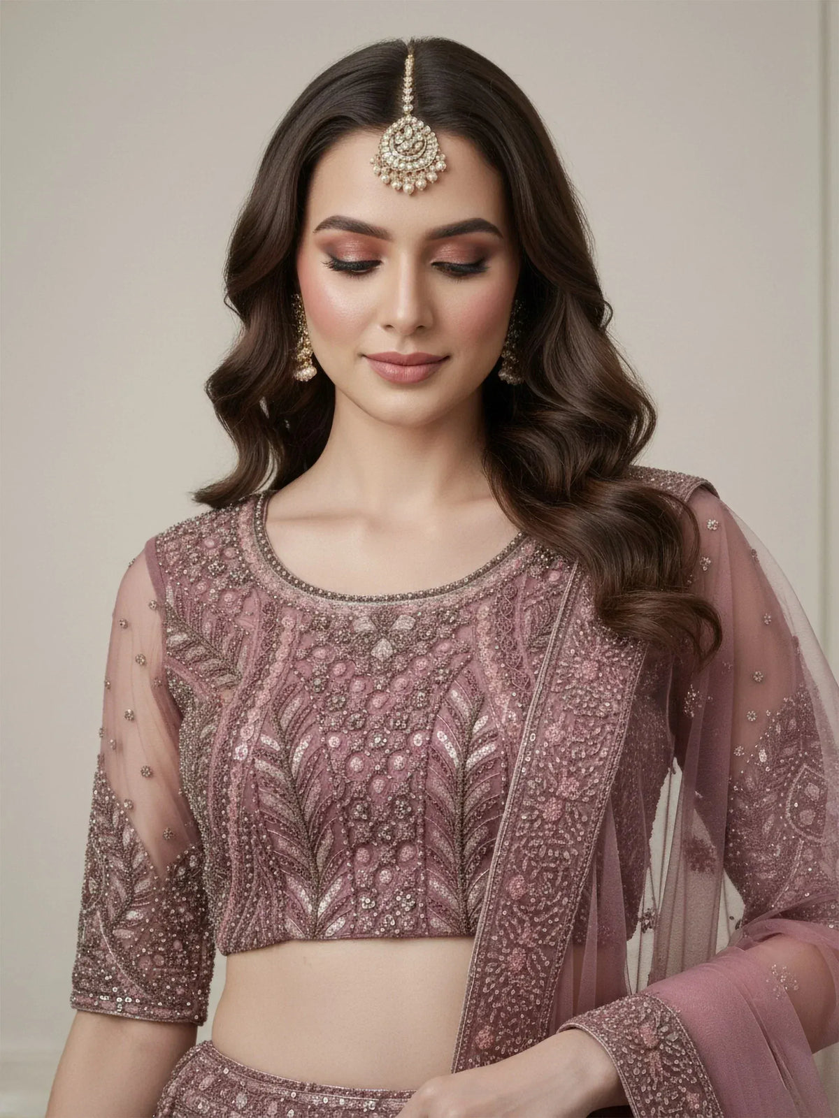Elegant mauve embroidered lehenga choli with sheer sleeves and matching dupatta, perfect for Indian weddings and festive occasions.