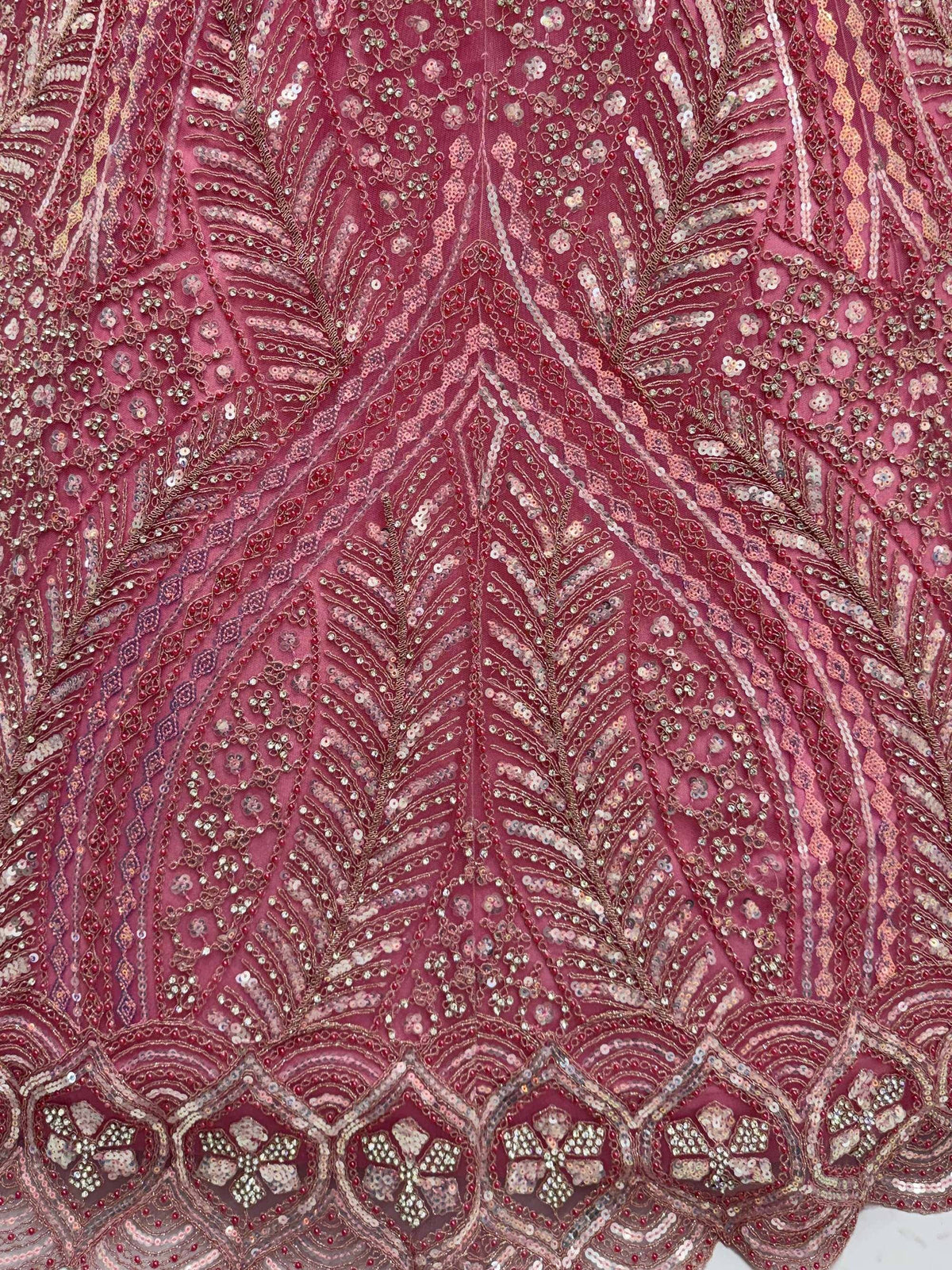Intricate maroon ethnic wear with sequin and bead embroidery, featuring floral and leaf patterns for designer lehenga or saree.