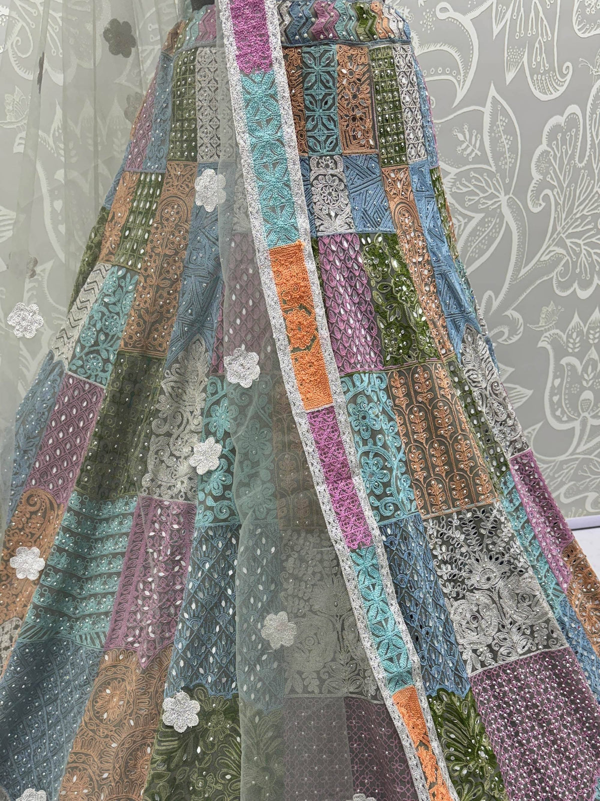 Colorful patchwork lehenga with intricate embroidery and floral appliques, perfect for ethnic wear.