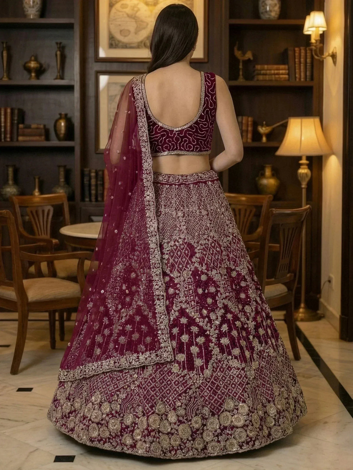Elegant maroon lehenga choli with intricate silver embroidery and floral motifs, perfect for Indian ethnic wear.