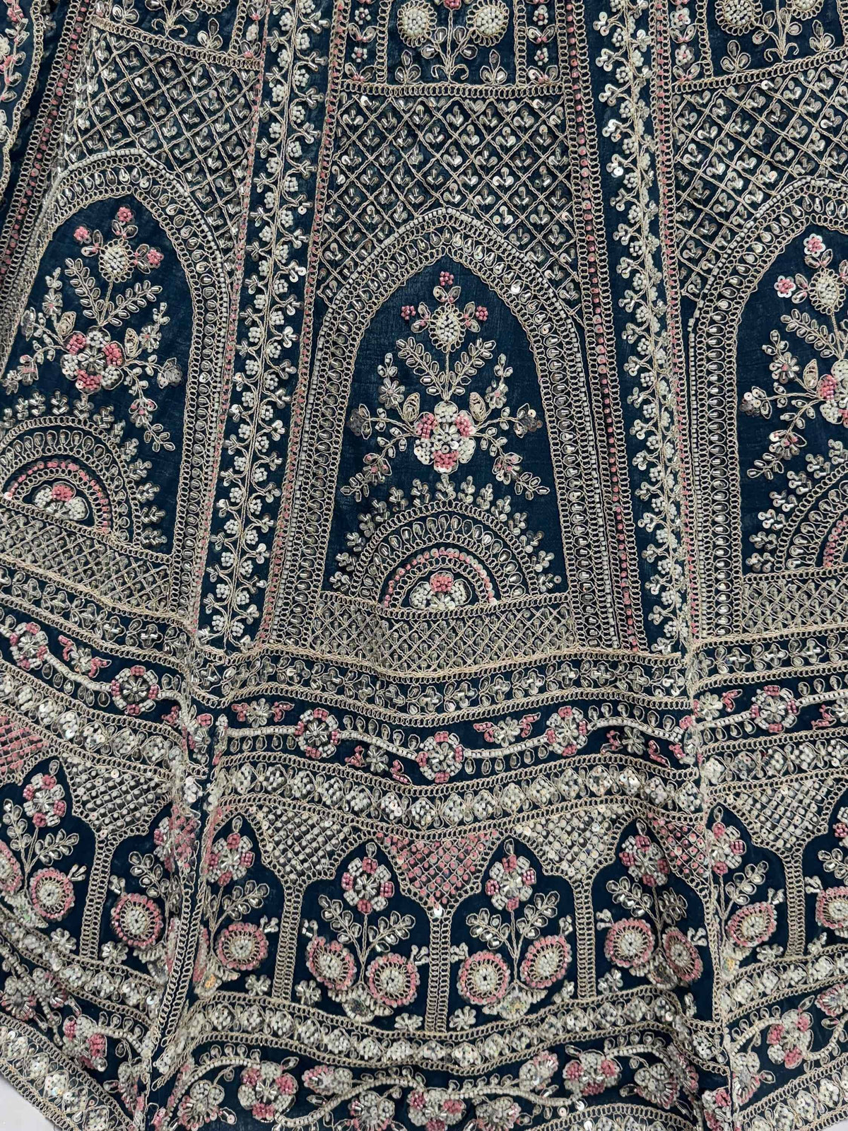 Dark blue velvet with intricate gold and pink floral embroidery, perfect for designer lehenga choli or ethnic gowns.