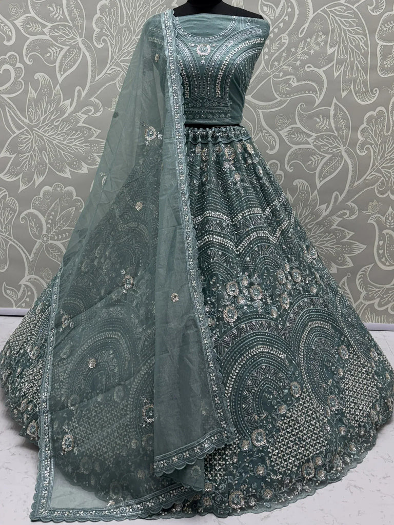 Emerald green designer lehenga choli with heavy silver embroidery and matching dupatta, perfect for weddings and festive occasions.