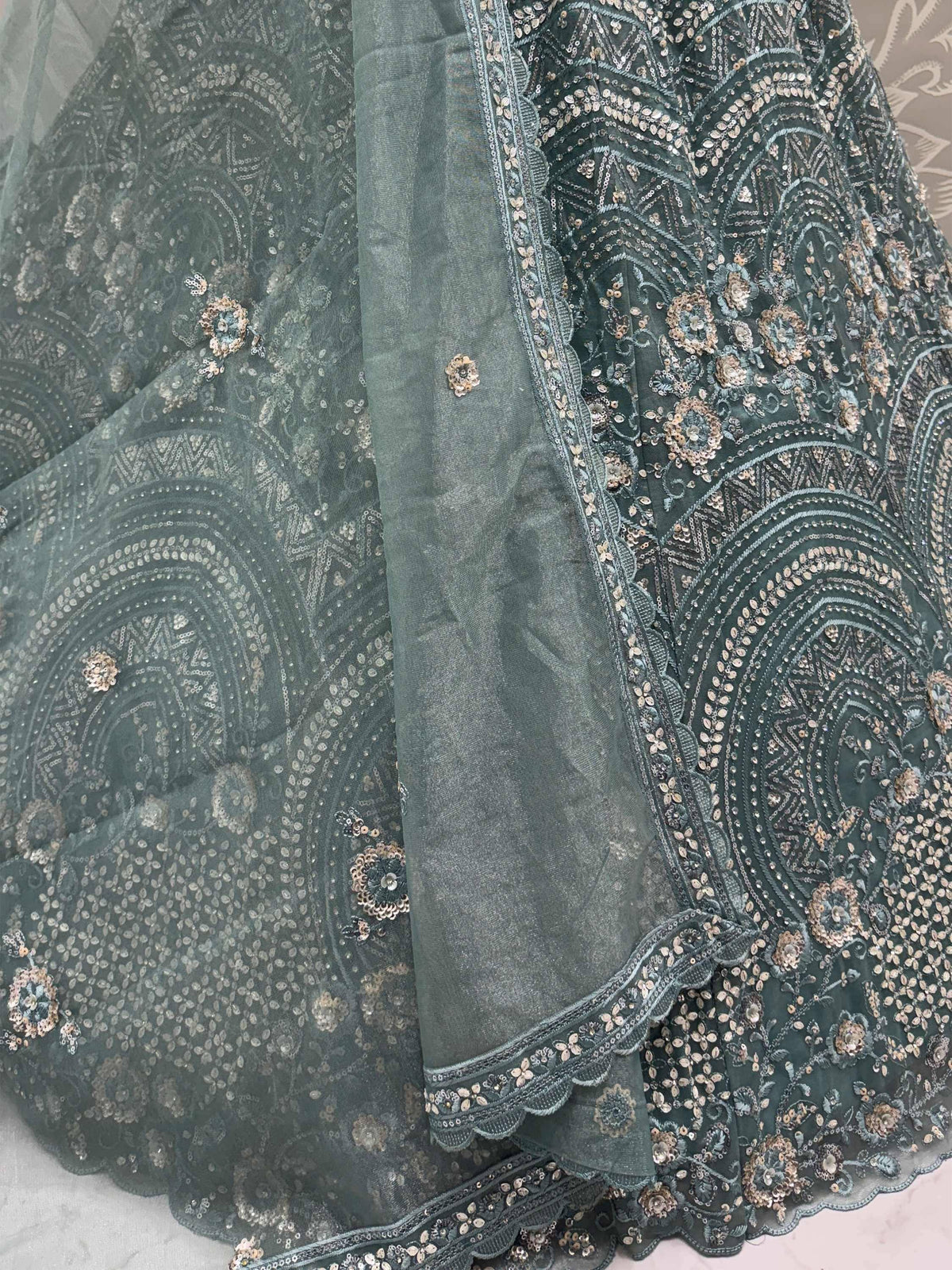 Dark green embroidered lehenga with gold sequins and floral motifs, perfect for Indian ethnic wear.