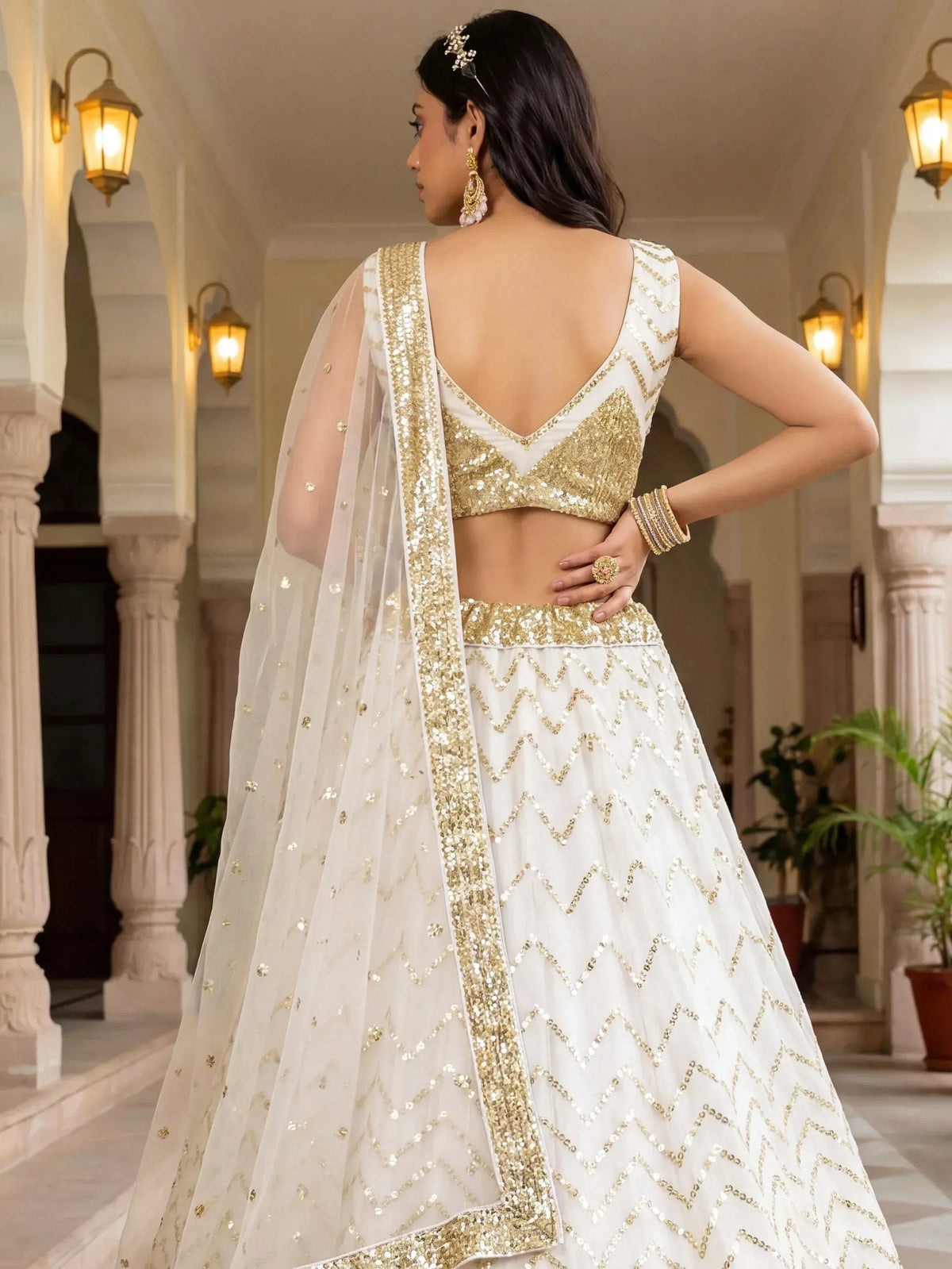White and gold sequin lehenga choli with chevron pattern, back view, ethnic wear for weddings