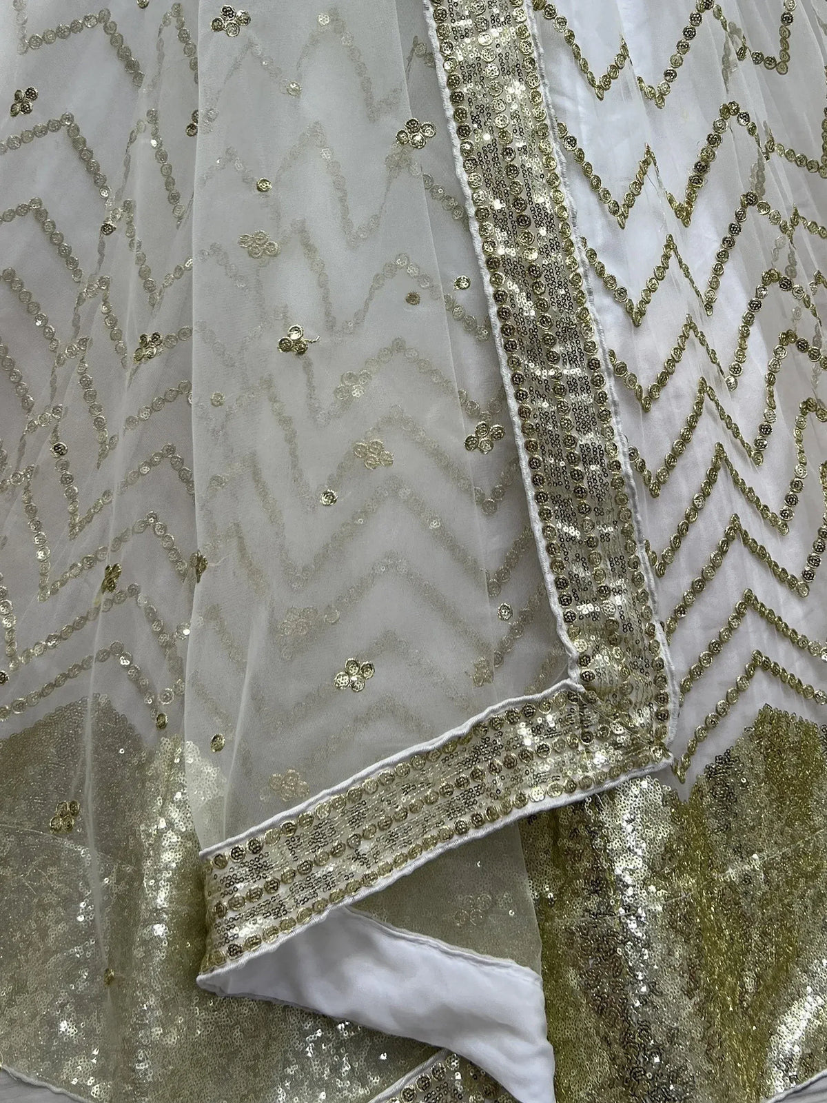 White and gold sequin ethnic wear with geometric patterns and floral embroidery details