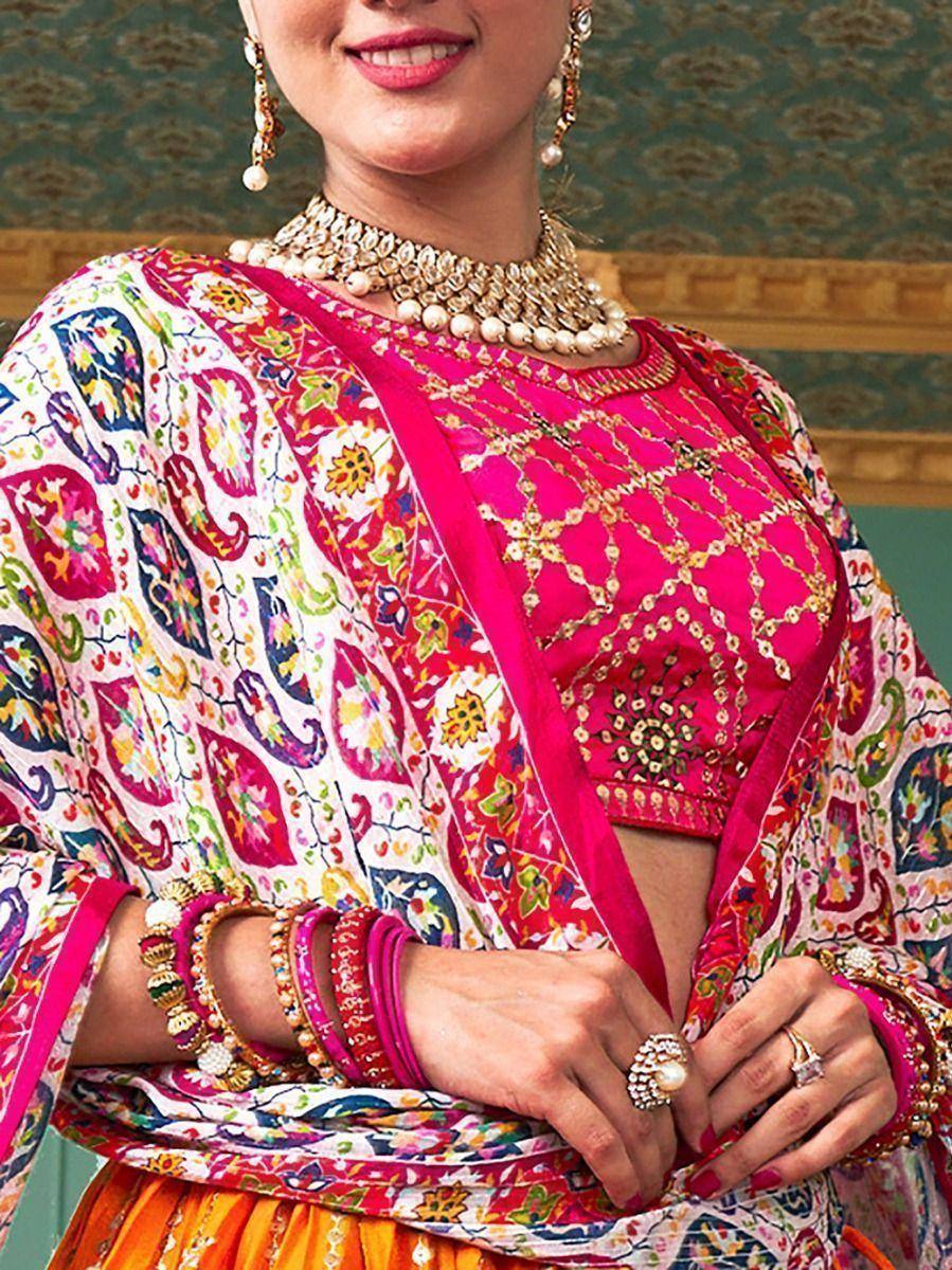 Vibrant pink embroidered lehenga choli with colorful paisley dupatta, traditional Indian ethnic wear