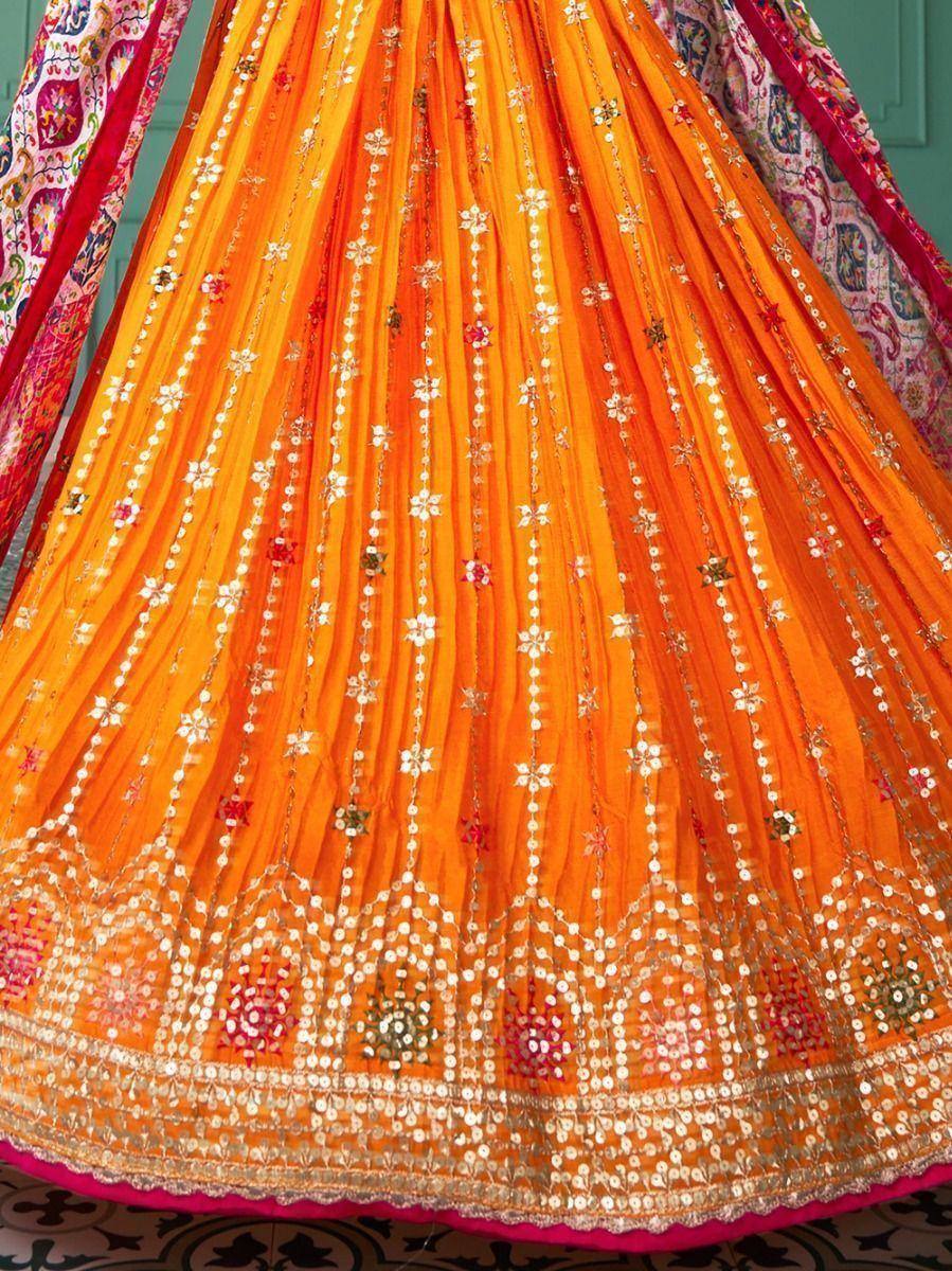 Vibrant orange lehenga with mirror work and floral embroidery, perfect for Indian ethnic wear