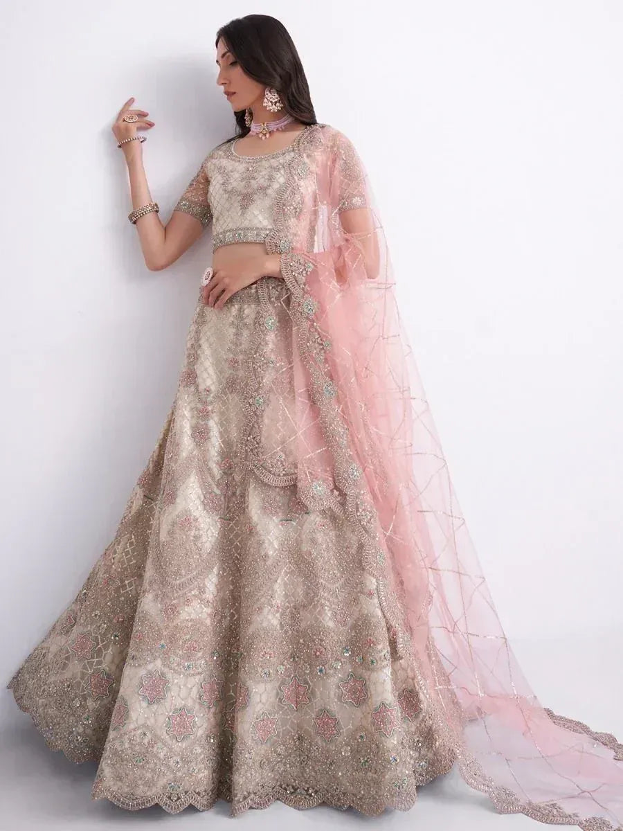 Elegant beige embroidered lehenga choli with pink dupatta, perfect for Indian weddings and festive occasions.