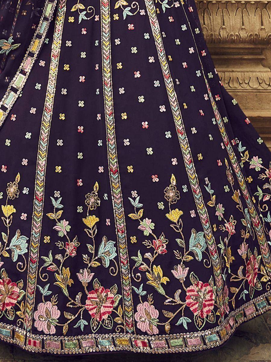 Dark navy lehenga with vibrant floral embroidery and colorful border detailing, perfect for Indian ethnic wear.