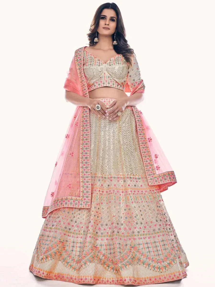 Elegant ivory and pink embroidered lehenga choli with floral dupatta, perfect for Indian weddings and festivals