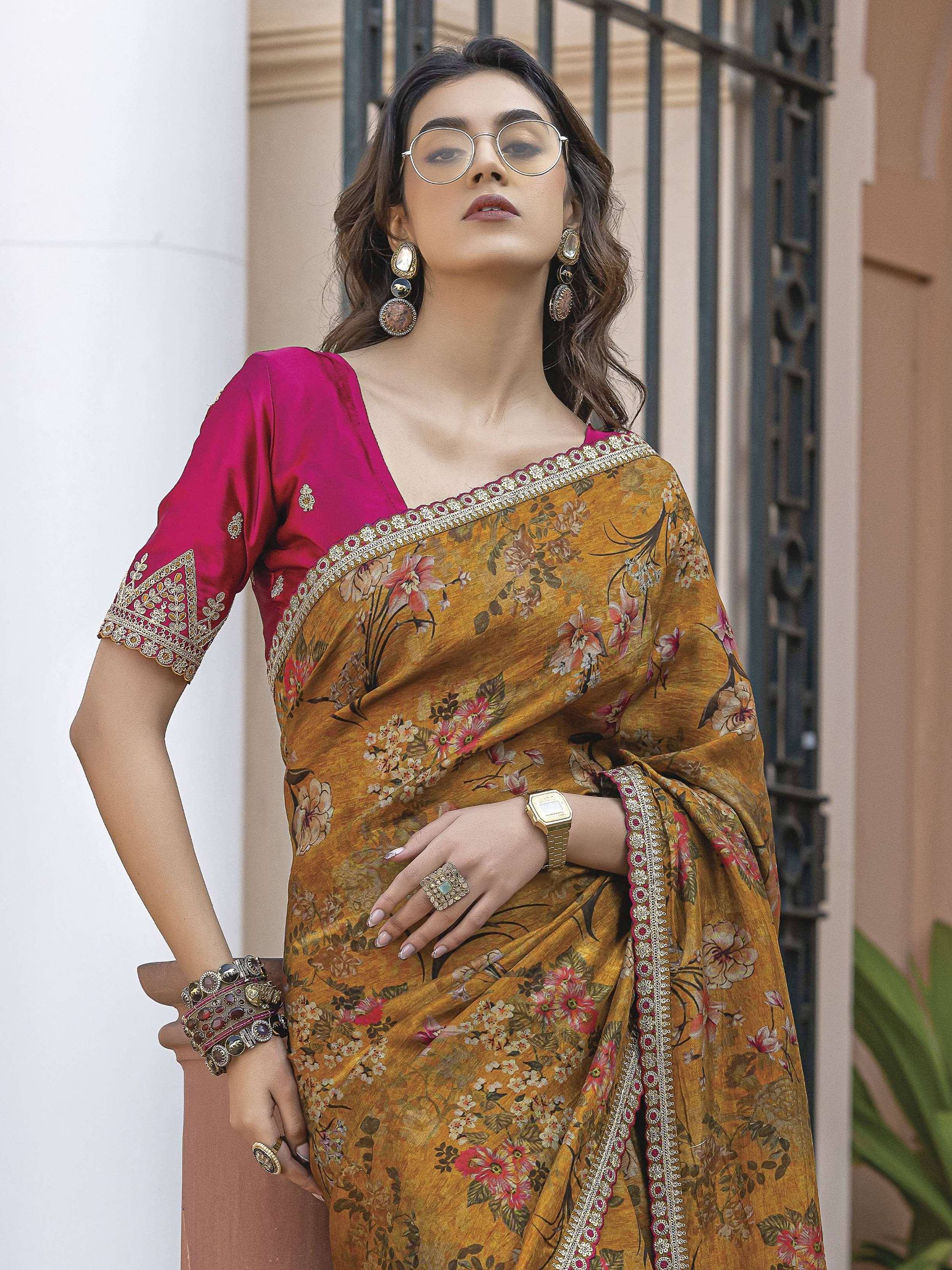 Woman in floral mustard saree with pink blouse, ethnic jewelry, and glasses