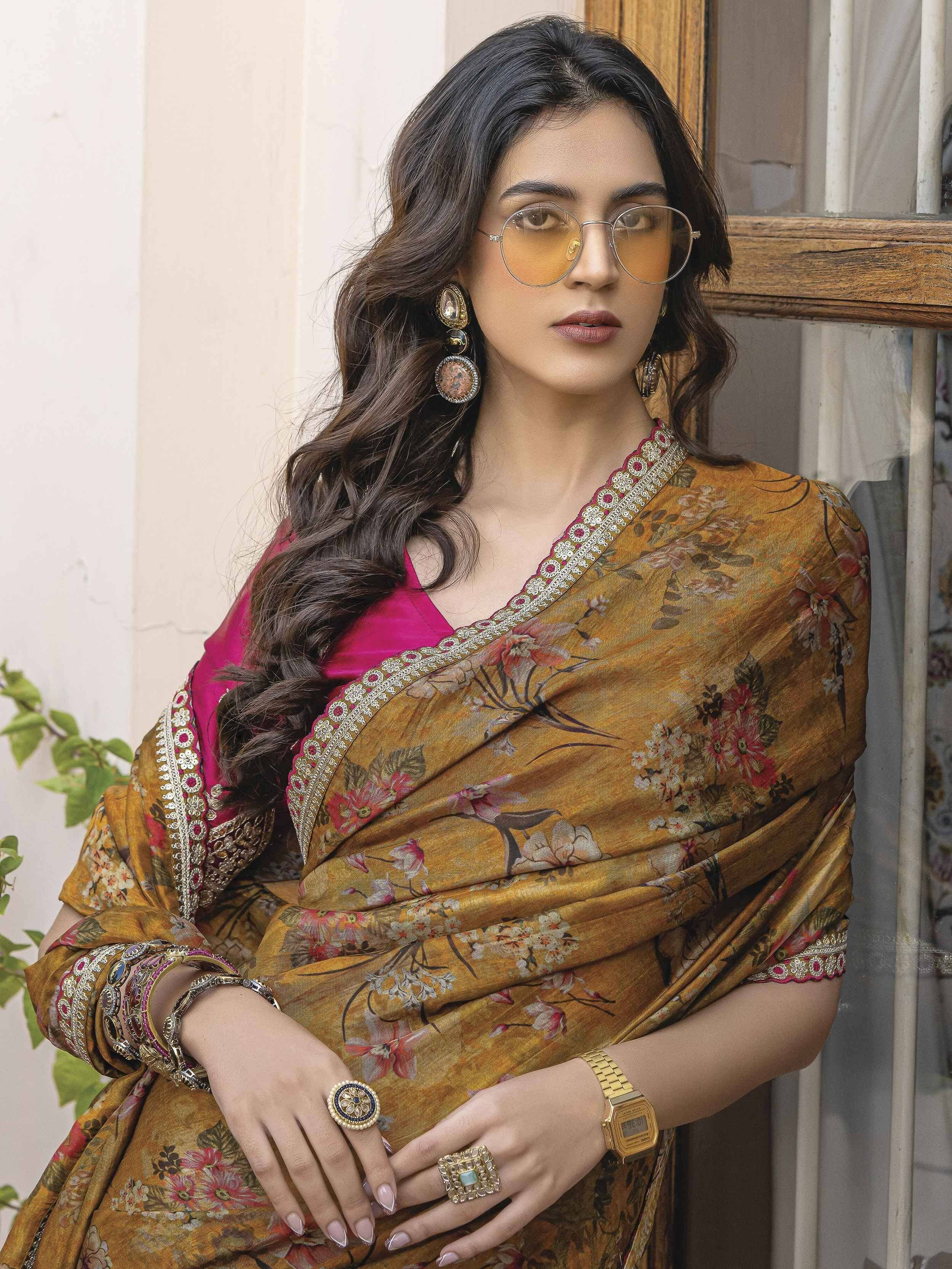 Woman in floral printed saree with pink blouse, ethnic jewelry, and sunglasses