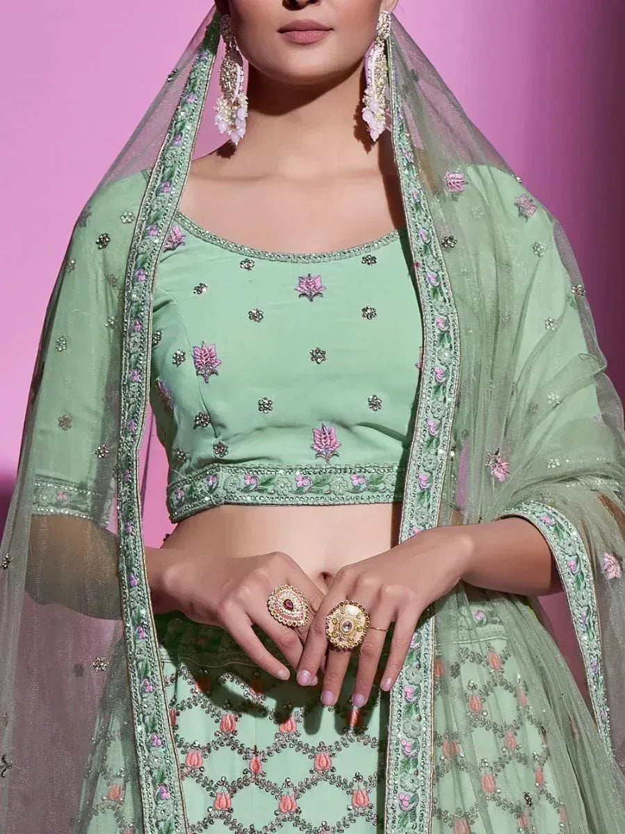 Mint green embroidered lehenga choli with floral motifs and sheer dupatta, perfect for Indian ethnic wear occasions
