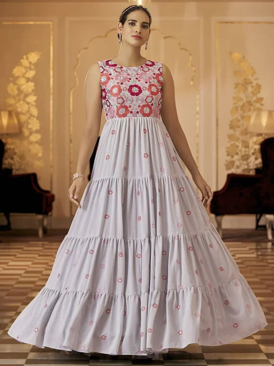 Woman in sleeveless floral embroidered ethnic gown with flared skirt in elegant setting