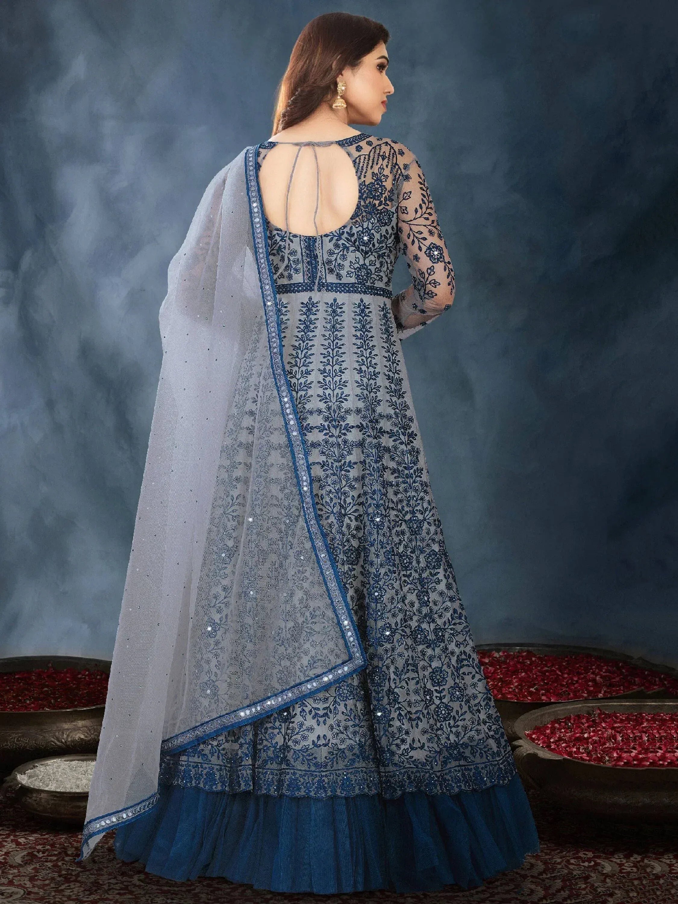 Blue embroidered designer lehenga choli with sheer dupatta, floral motifs, and open back detail