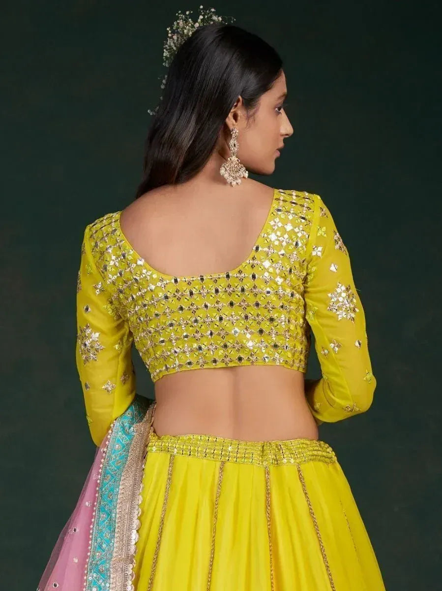 Yellow designer lehenga choli with mirror work, back view, ethnic Indian wear