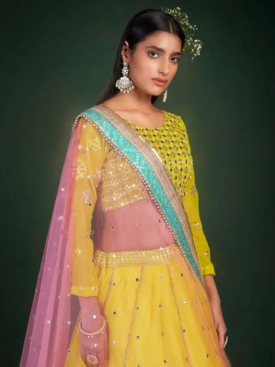 Yellow designer lehenga choli with pink dupatta, perfect for Indian ethnic wear occasions
