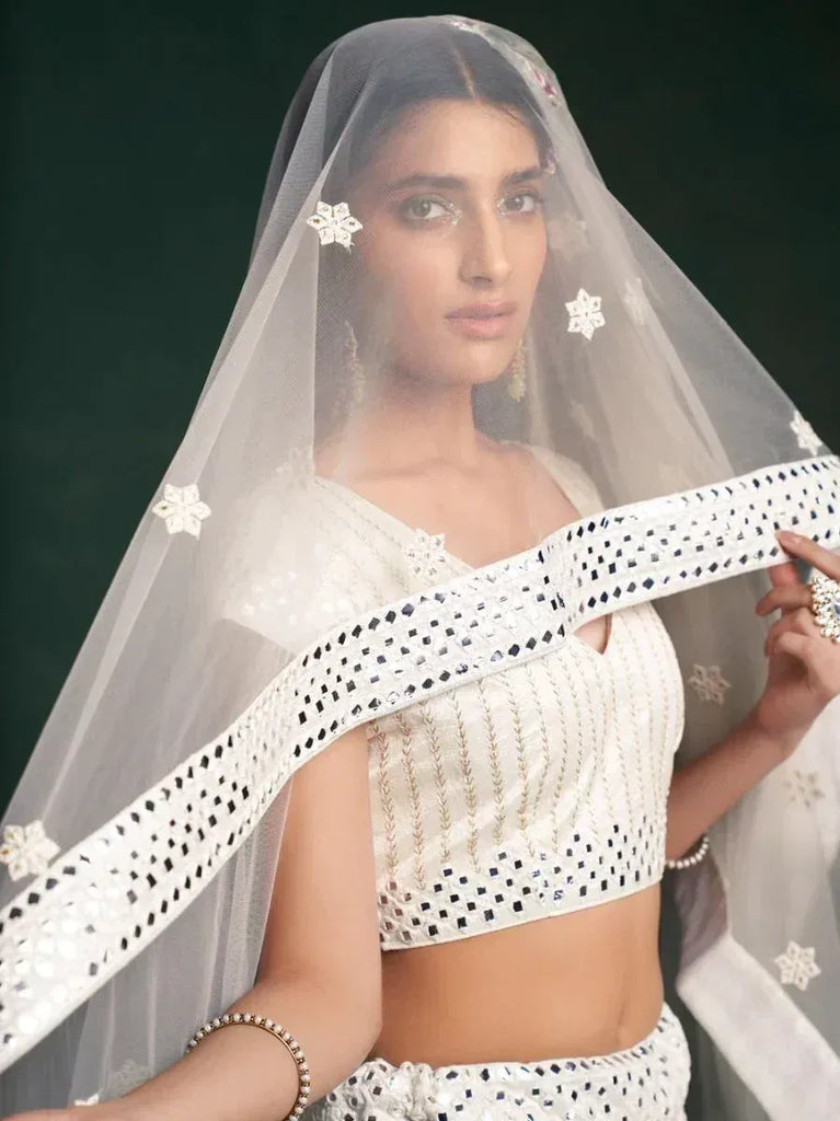 White embroidered lehenga choli with floral veil, Indian bridal wear