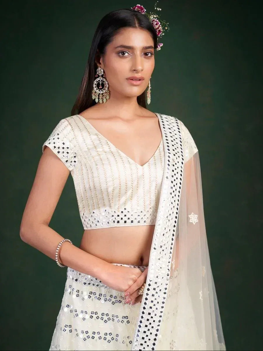White embroidered lehenga choli with mirror work and sheer dupatta, perfect for Indian ethnic occasions