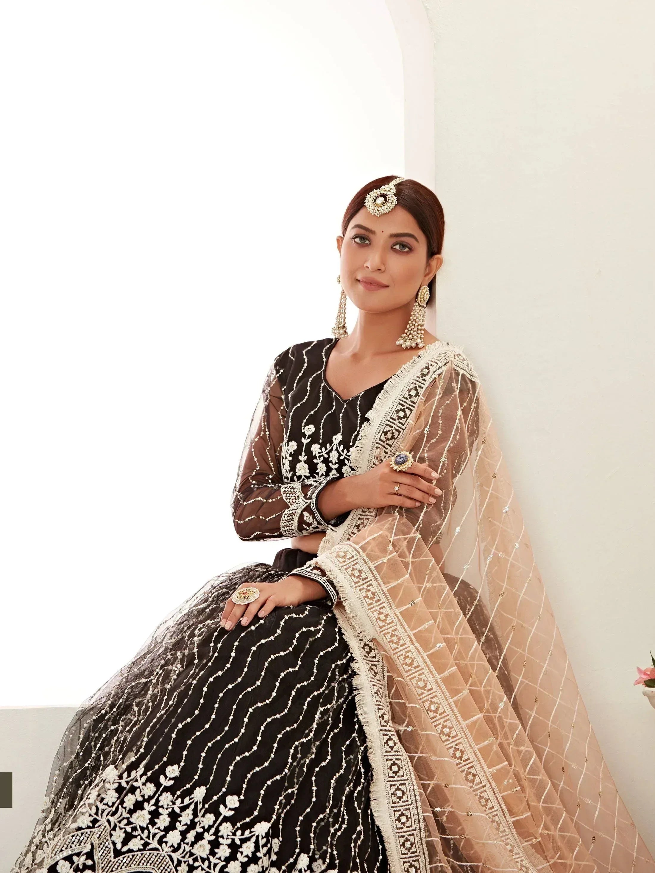 Black and gold embroidered lehenga choli with sheer dupatta, perfect for Indian ethnic wear occasions