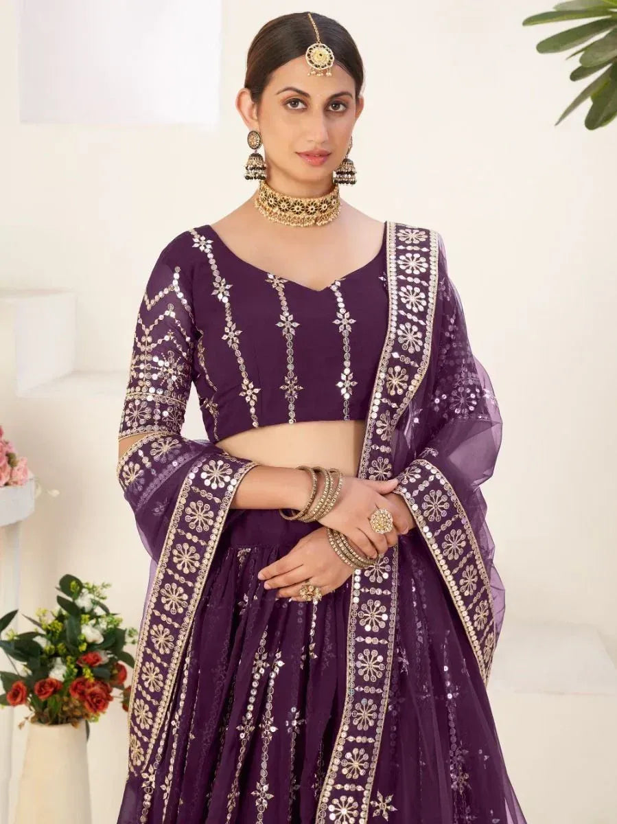 Purple designer lehenga choli with gold mirror work and floral embroidery, perfect for Indian ethnic occasions.