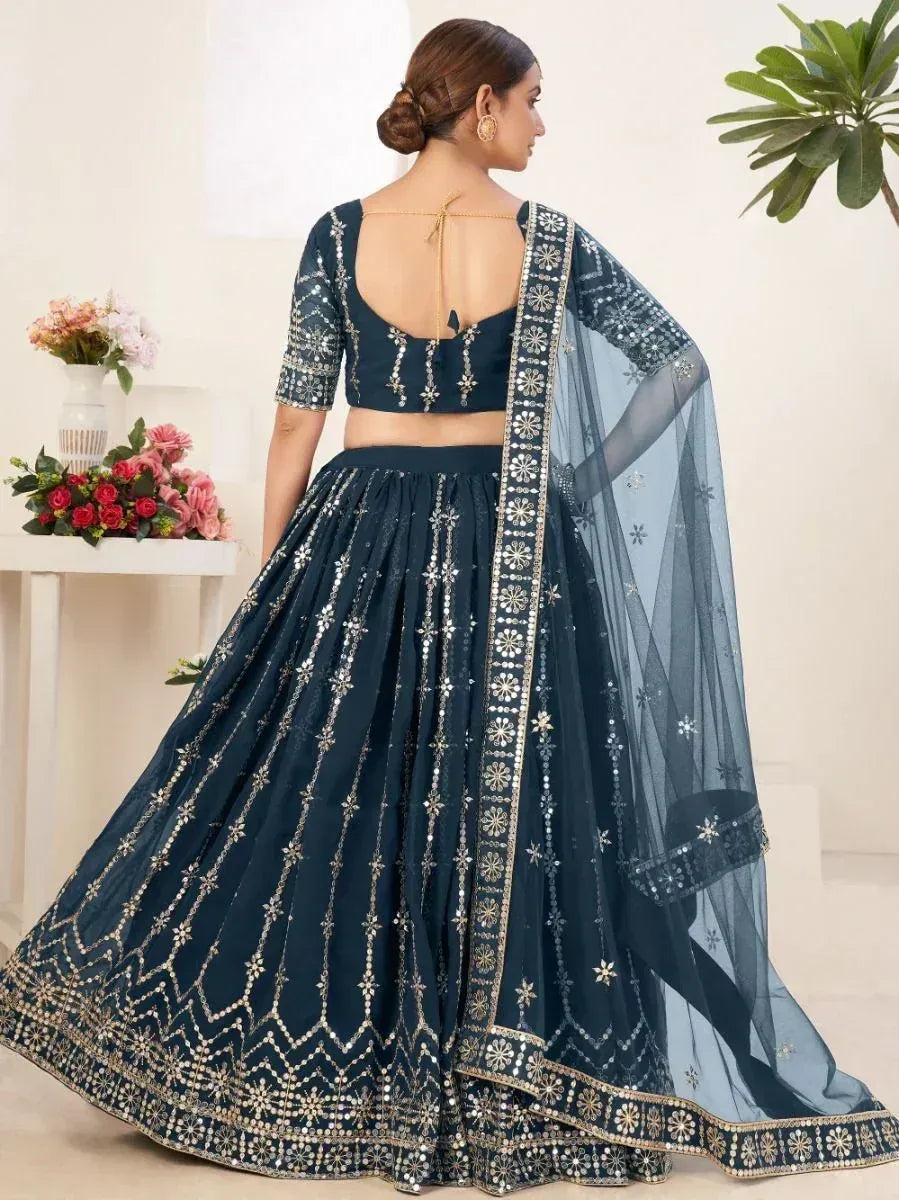 Navy blue designer lehenga choli with gold mirror work and sheer dupatta, perfect for Indian ethnic occasions