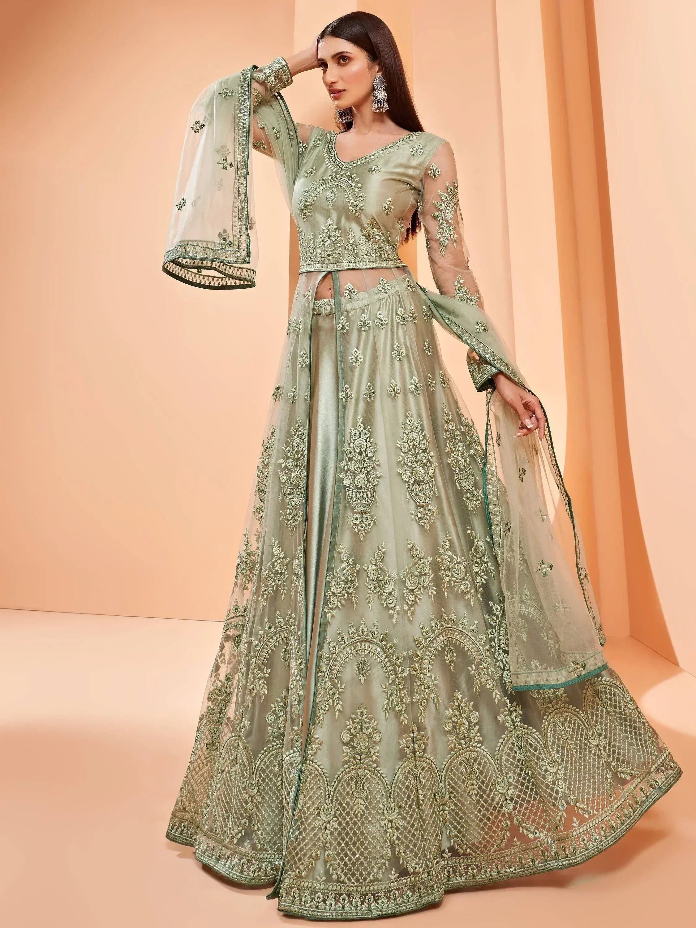 Mint green embroidered lehenga choli with sheer dupatta, perfect for Indian weddings and festive occasions.
