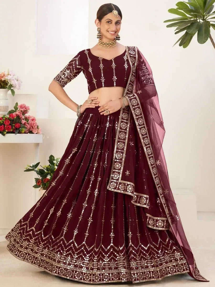 Maroon lehenga choli with gold mirror work and floral embroidery, perfect for Indian weddings and festive occasions.