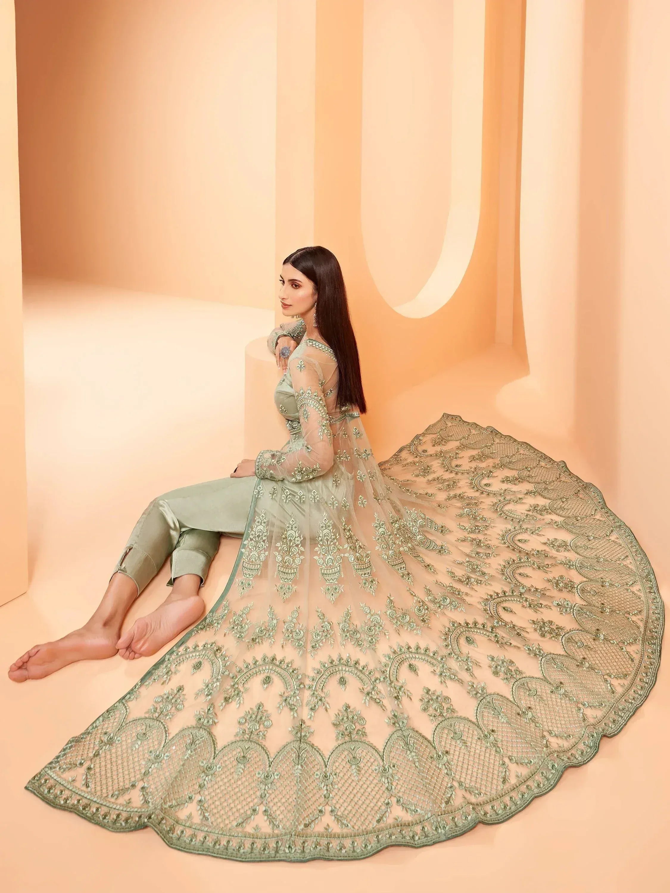 Elegant mint green embroidered lehenga choli with sheer dupatta, perfect for Indian ethnic wear.