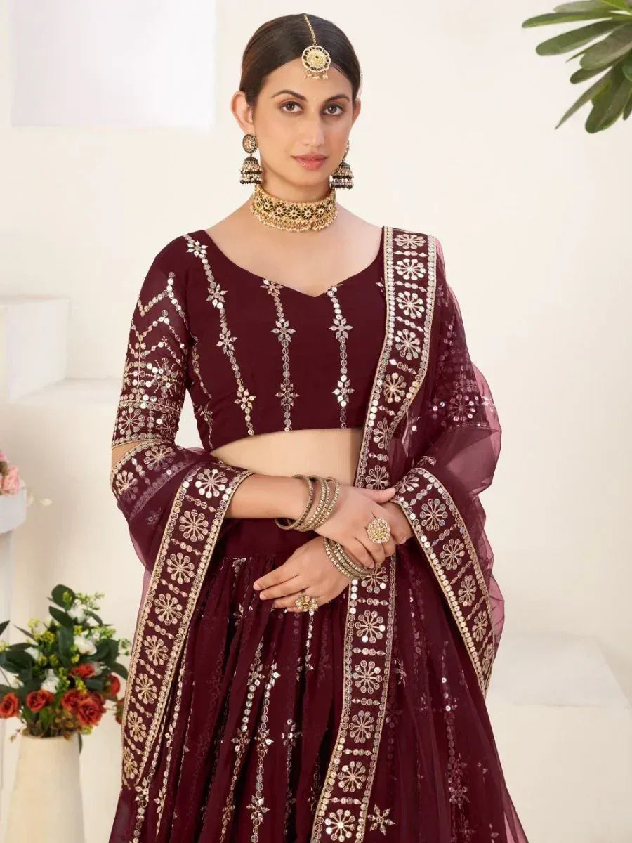 Maroon designer lehenga choli with gold mirror work and floral embroidery, perfect for Indian ethnic occasions
