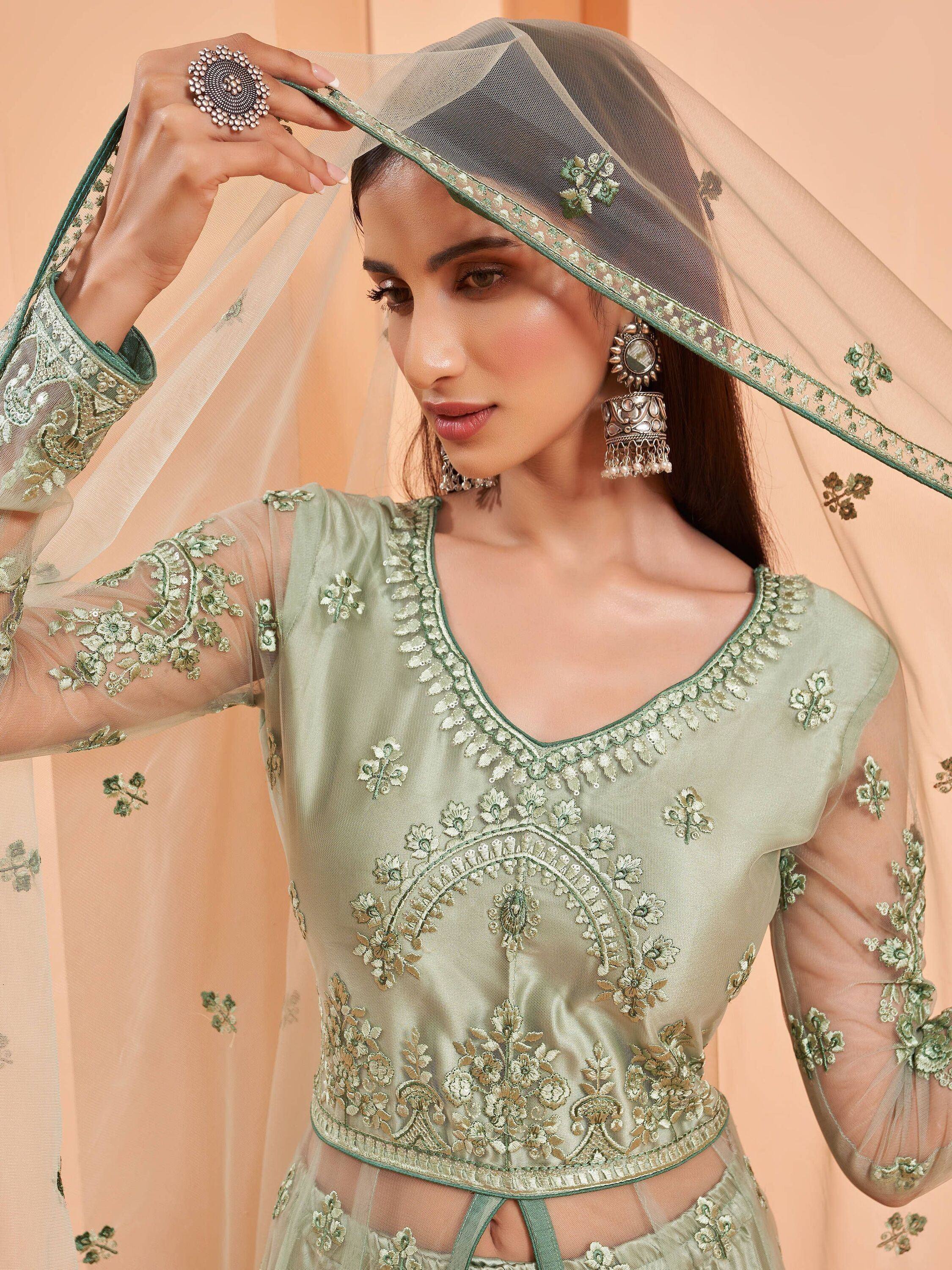 Mint green embroidered lehenga choli with sheer dupatta, floral embellishments, and traditional Indian bridal wear details