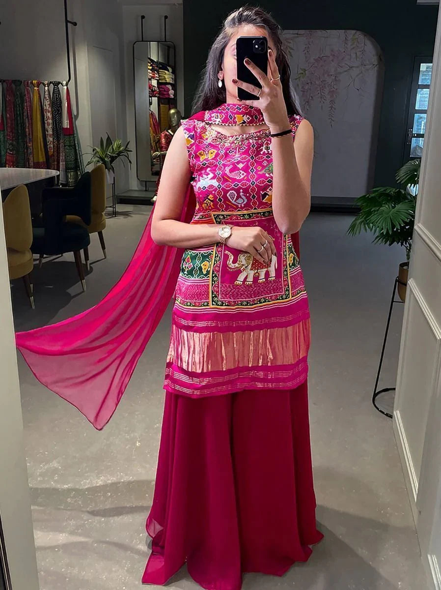 Woman in a pink ethnic lehenga choli with embroidered patterns and elephant motif, mirror selfie