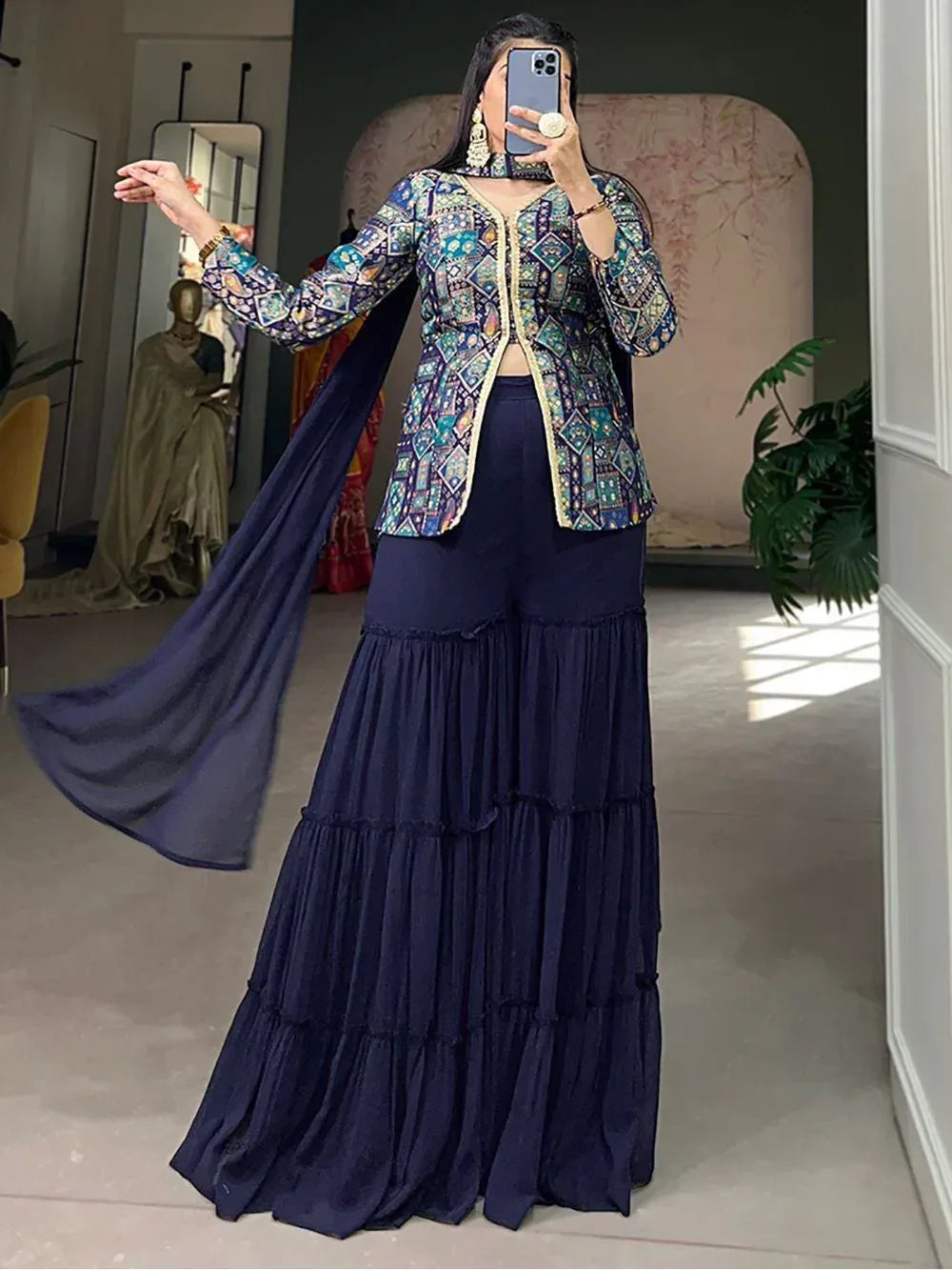 Woman in navy blue tiered palazzo pants with printed ethnic jacket and dupatta, perfect for Indian occasions
