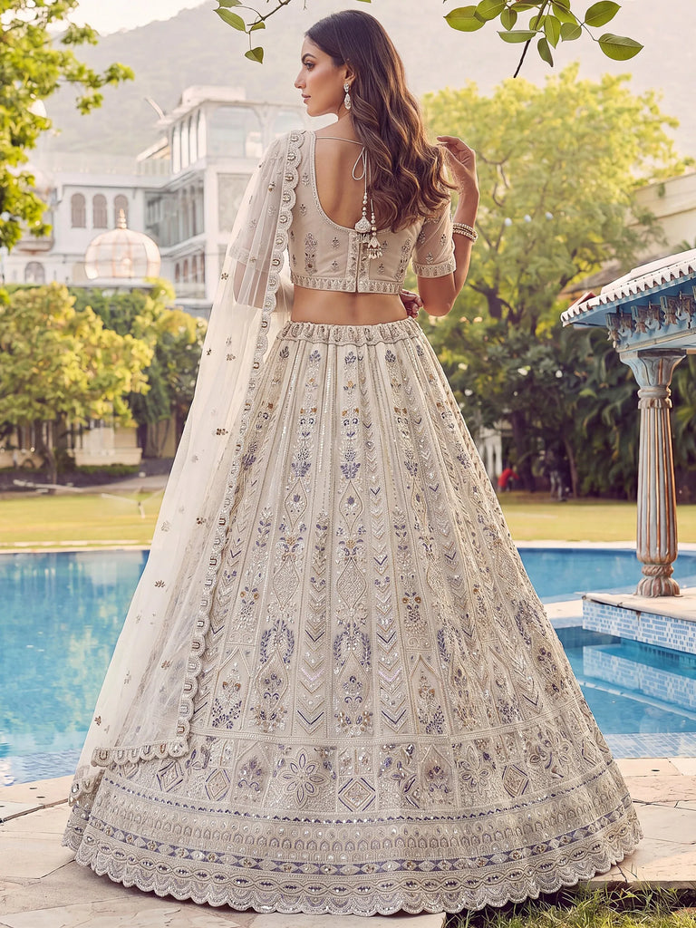 Charming Cream Embroidered Net Engagement Wear Lehenga Choli