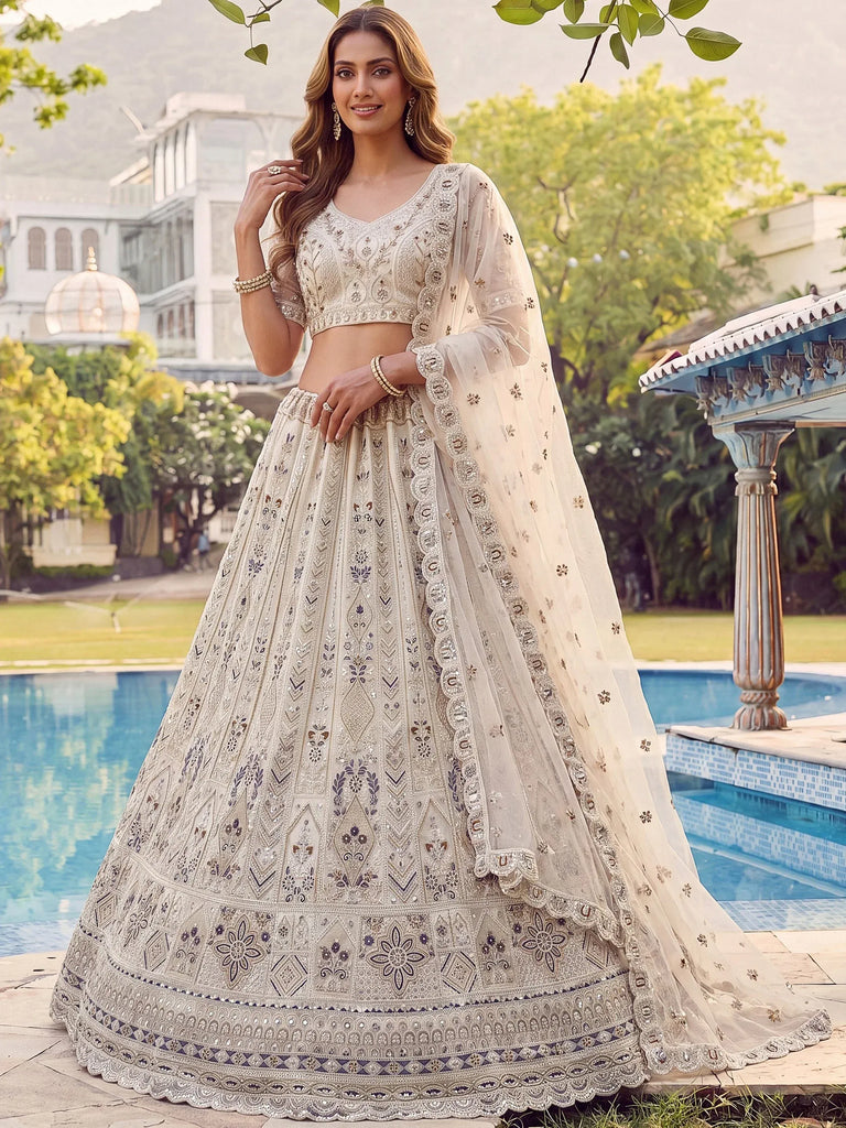 Charming Cream Embroidered Net Engagement Wear Lehenga Choli