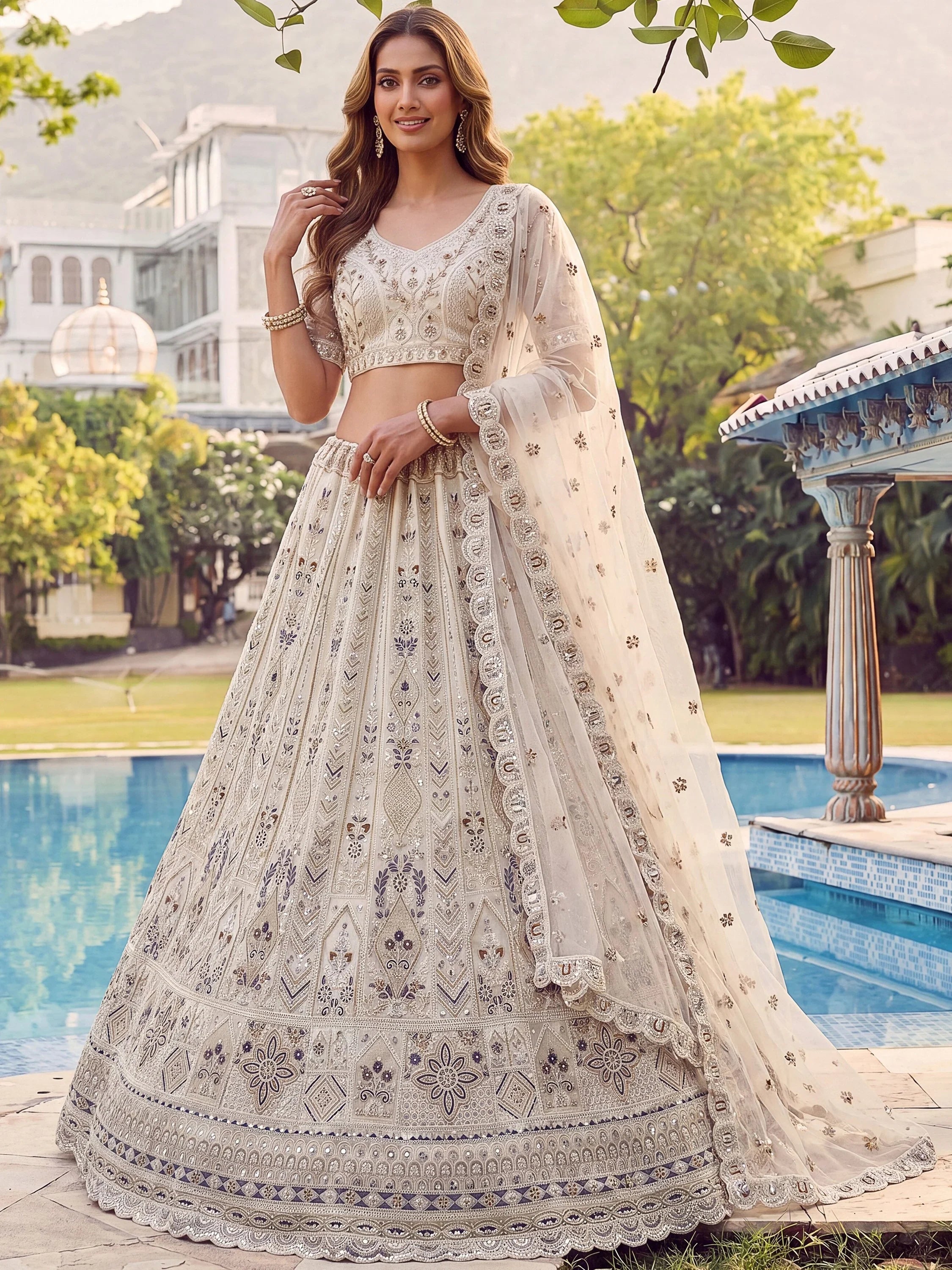 Charming Cream Embroidered Net Engagement Wear Lehenga Choli
