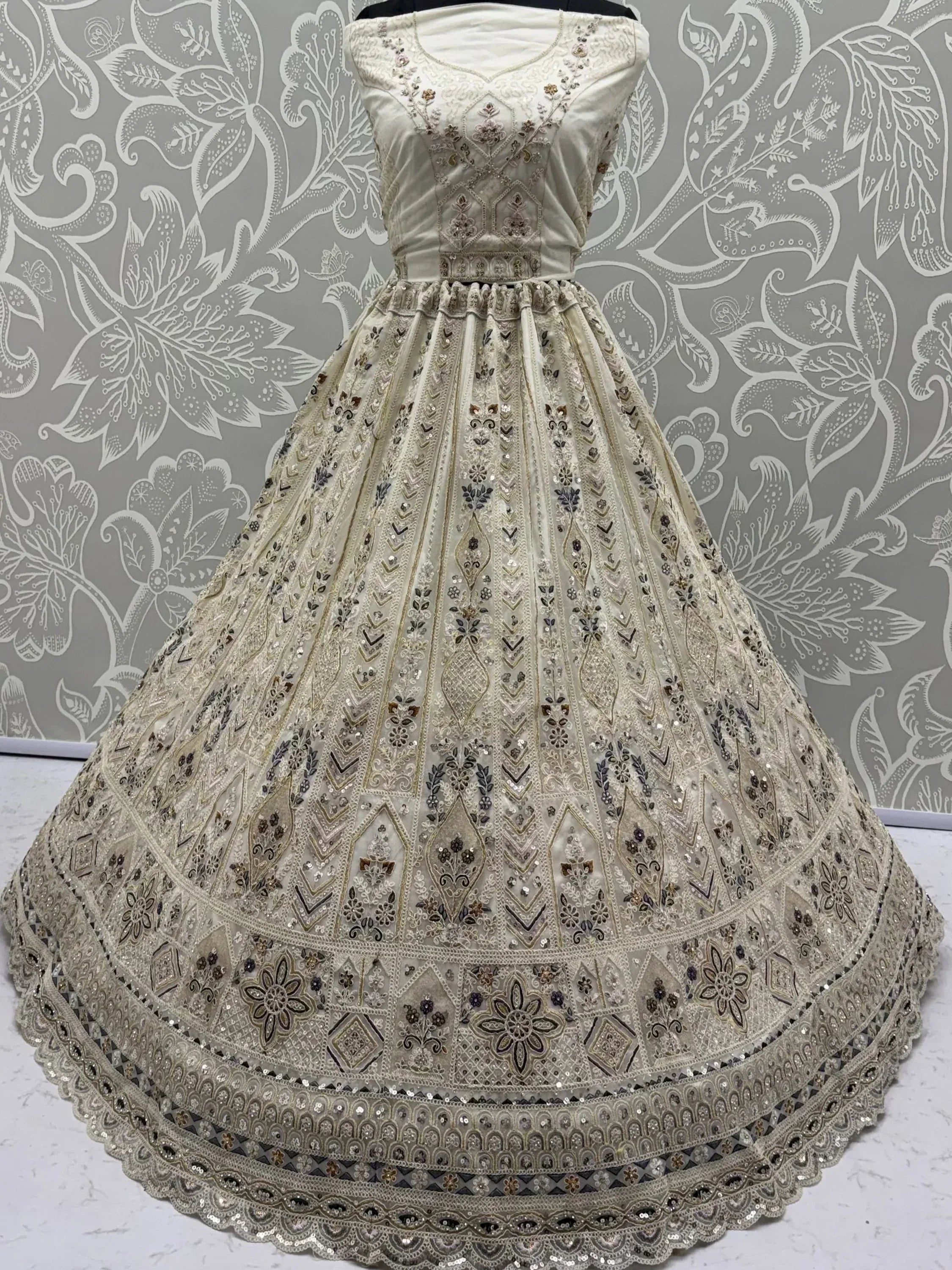 Charming Cream Embroidered Net Engagement Wear Lehenga Choli