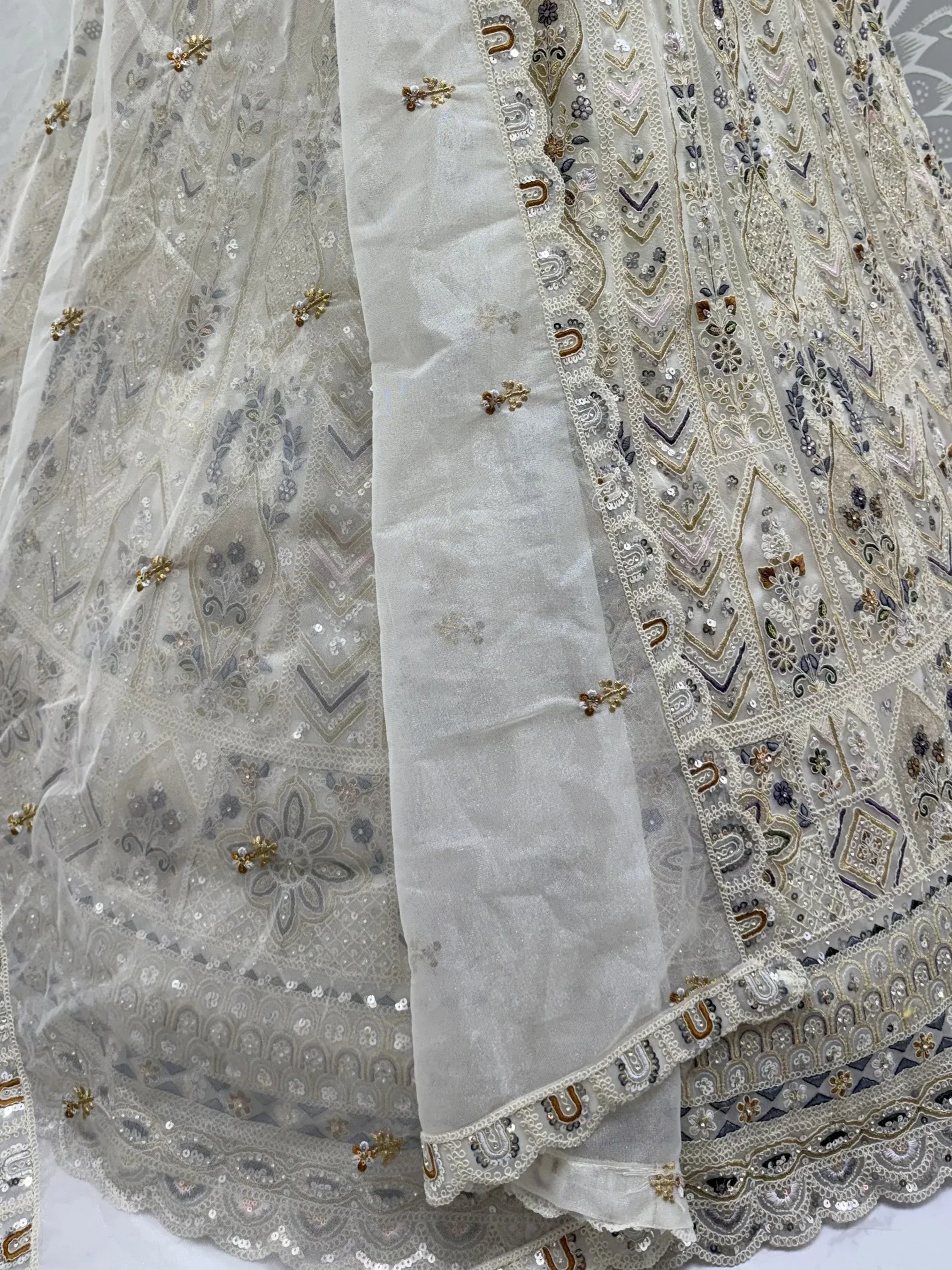 Charming Cream Embroidered Net Engagement Wear Lehenga Choli