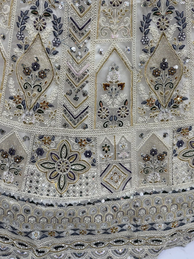 Charming Cream Embroidered Net Engagement Wear Lehenga Choli
