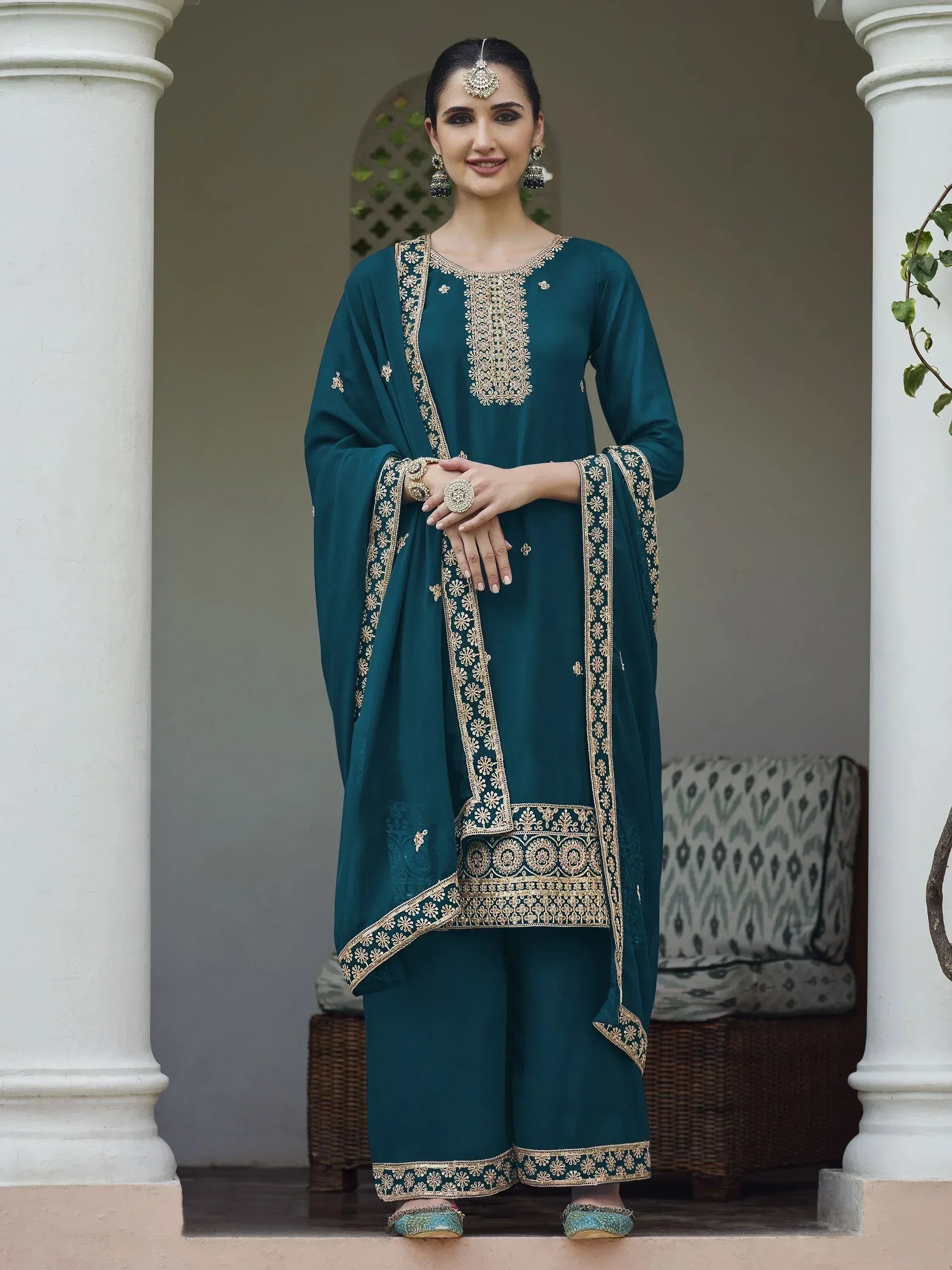 Woman wearing teal embroidered salwar kameez with dupatta, traditional Indian ethnic wear