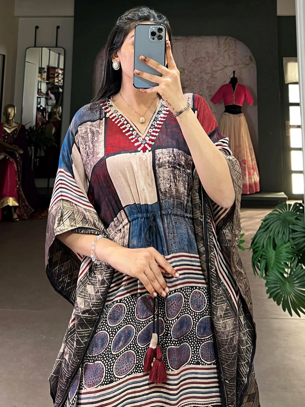 Woman wearing colorful ethnic printed kaftan with tassels, perfect for Indian festive occasions.
